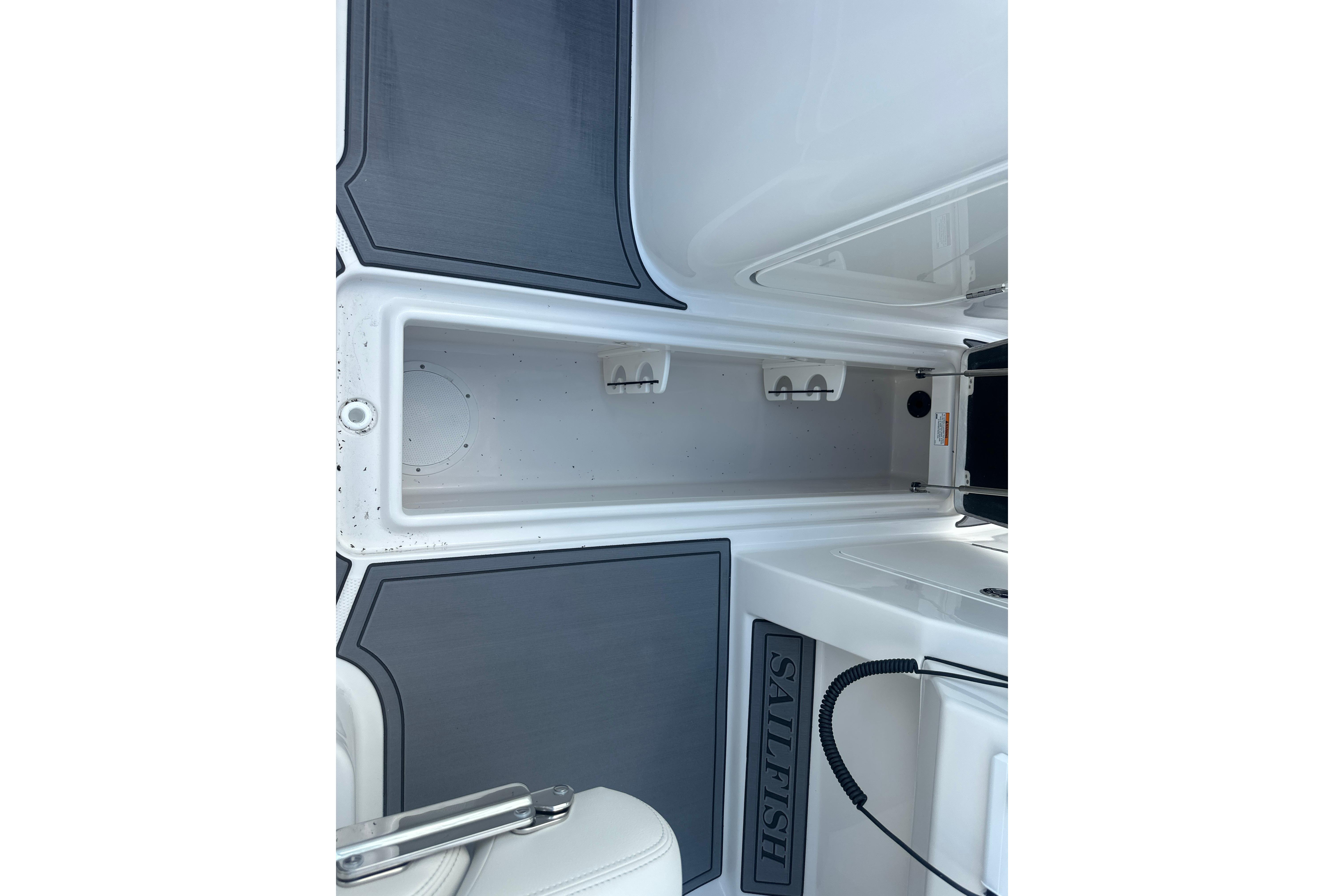 Interior view of 2026 Sailfish 226 DC boat, featuring storage compartment and sleek design.