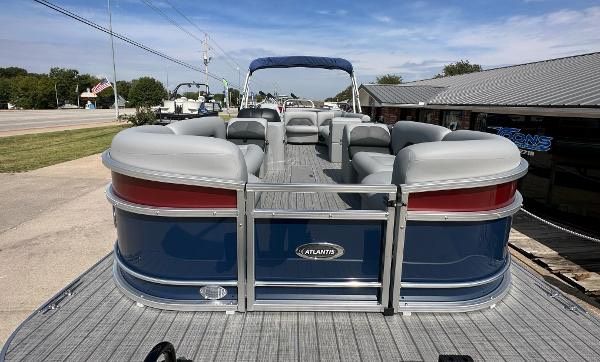 2024 Landau ATLANTIS 230C pontoon boat parked outdoors.