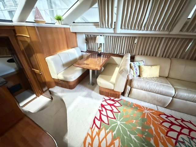 Interior of a 2005 Carver 44 Cockpit Motor Yacht with cozy seating area and table.