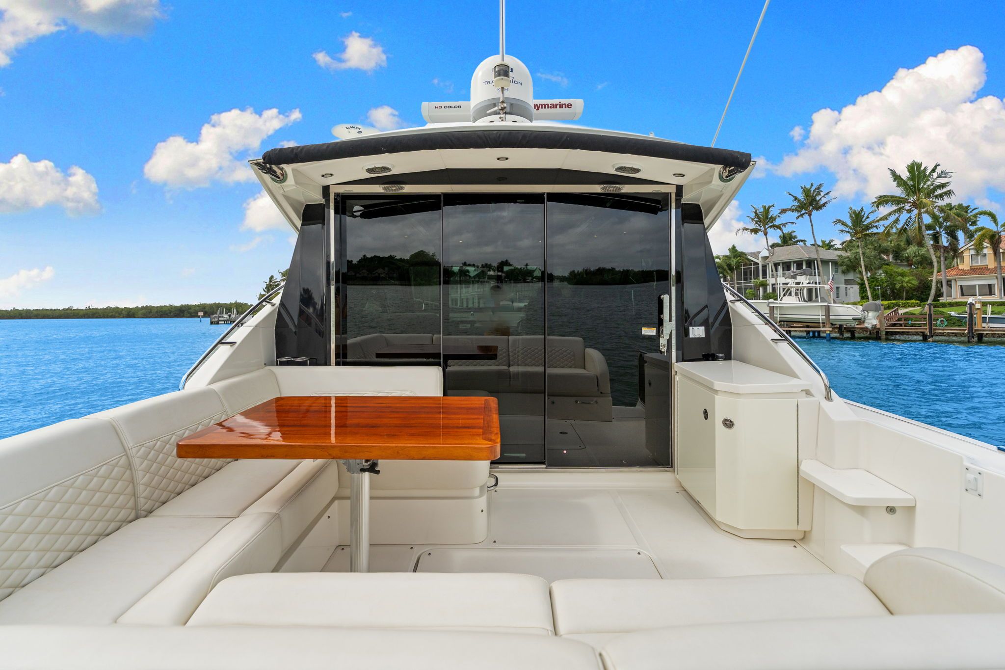 2017 Sea Ray Sundancer 510 with spacious cockpit and wooden table, on calm water.