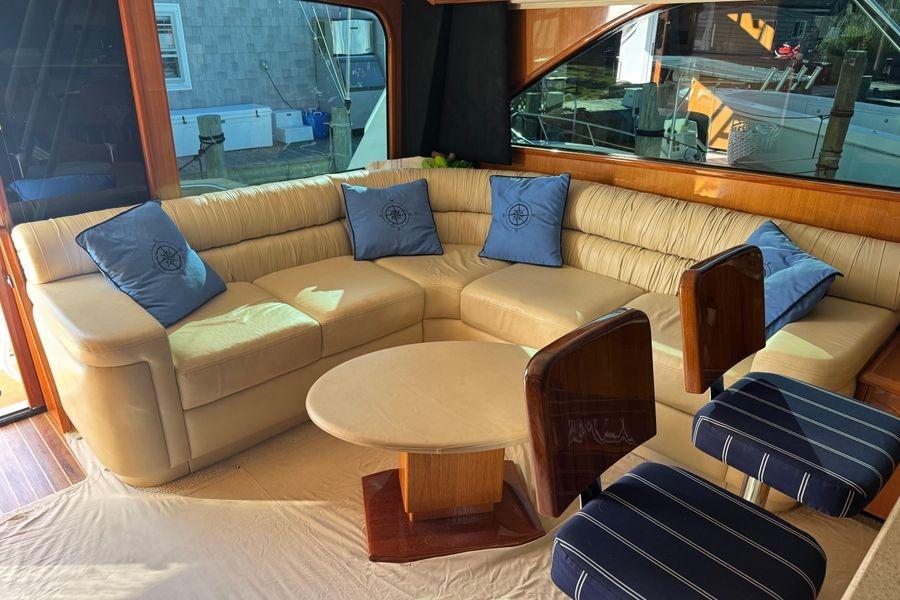 Luxurious interior of 2002 Viking 61 Enclosed Bridge yacht with plush seating and elegant decor.