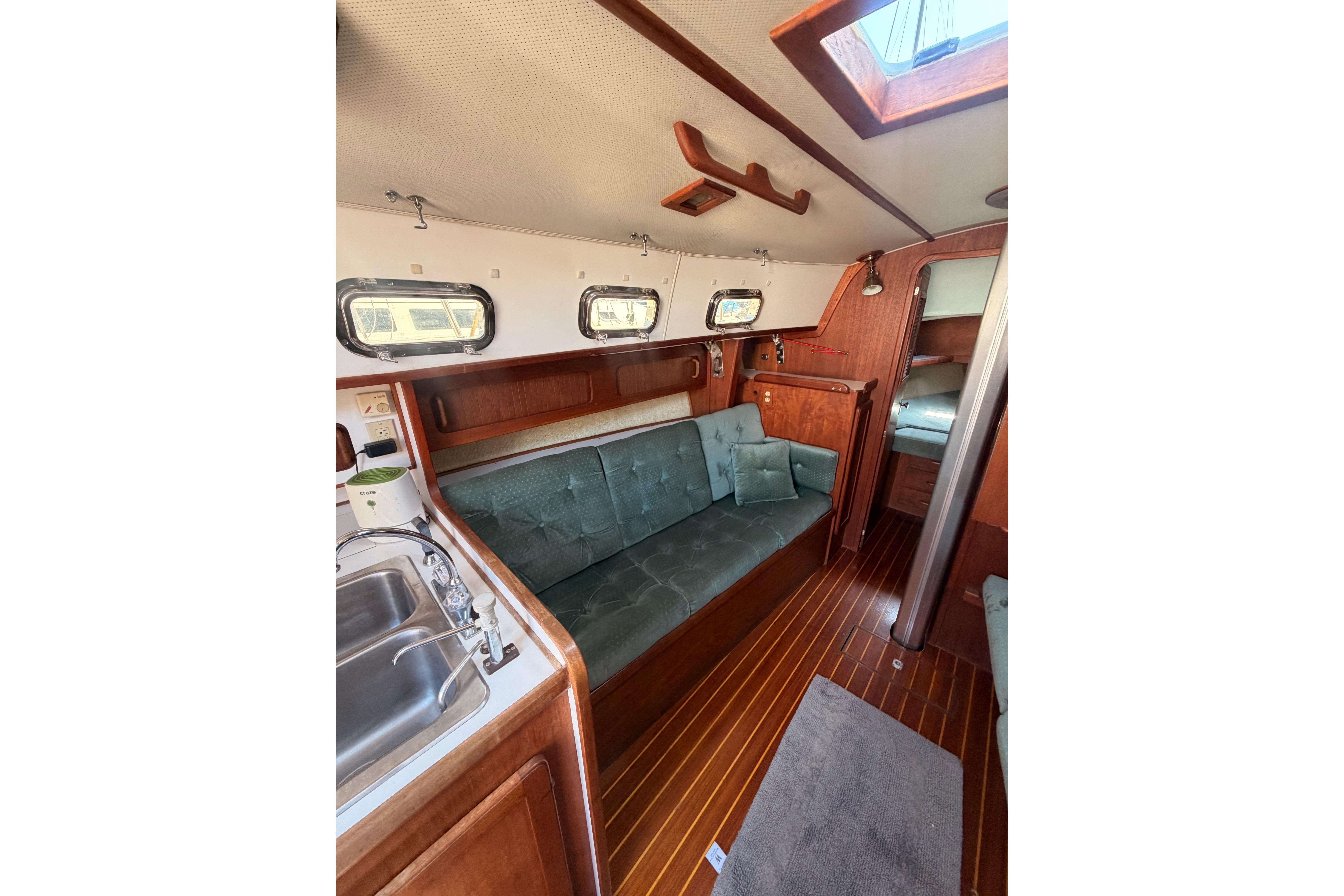 Interior of 1991 Caliber 33 sailboat with wood finish and cozy seating area.