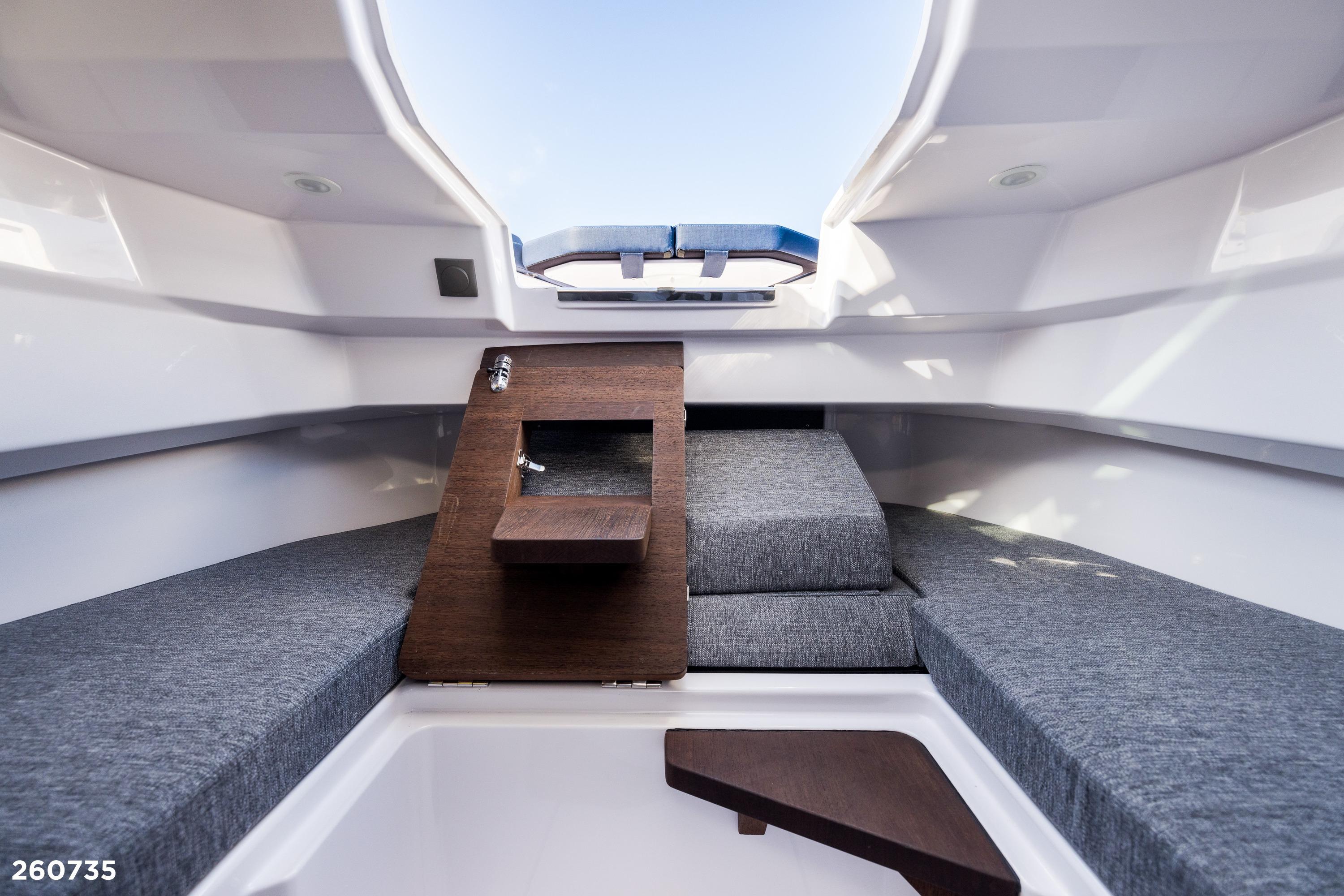 Interior cabin of 2026 Axopar 29 XC Cross Cabin with modern seating and wooden accents.