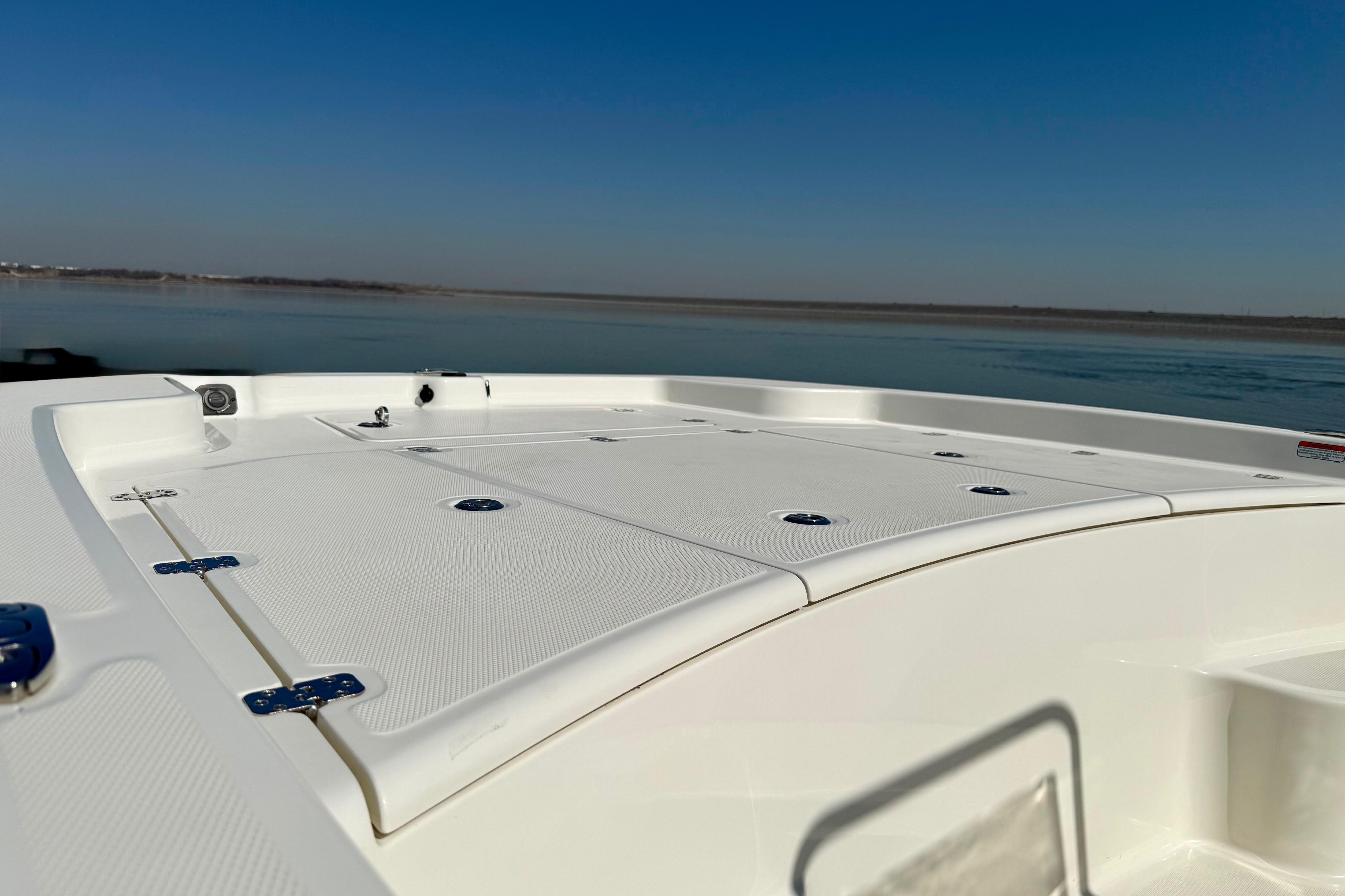 2024 Mako Pro Skiff 19 CC boat deck with calm water backdrop.