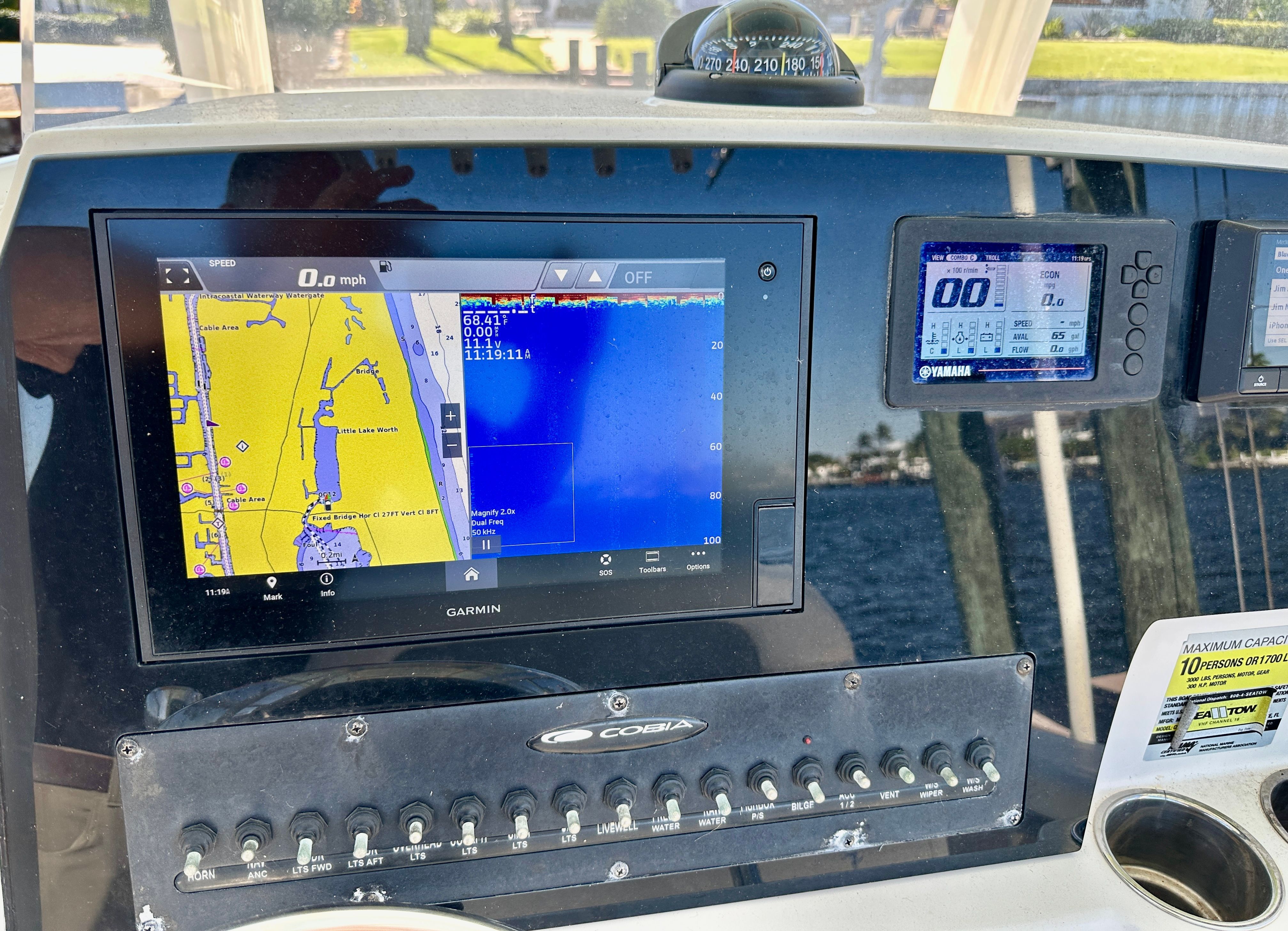 The dashboard of a 2022 Cobia 240 Center Console boat with navigation system.