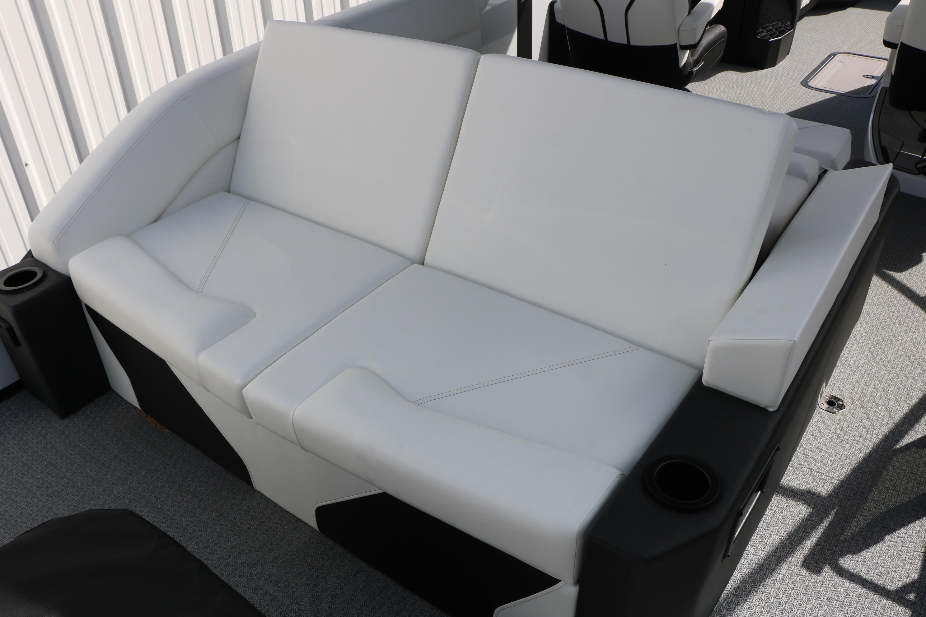 Luxurious white seating on 2026 Evotti 725 CS Tri-Toon boat, featuring cup holders and modern design.
