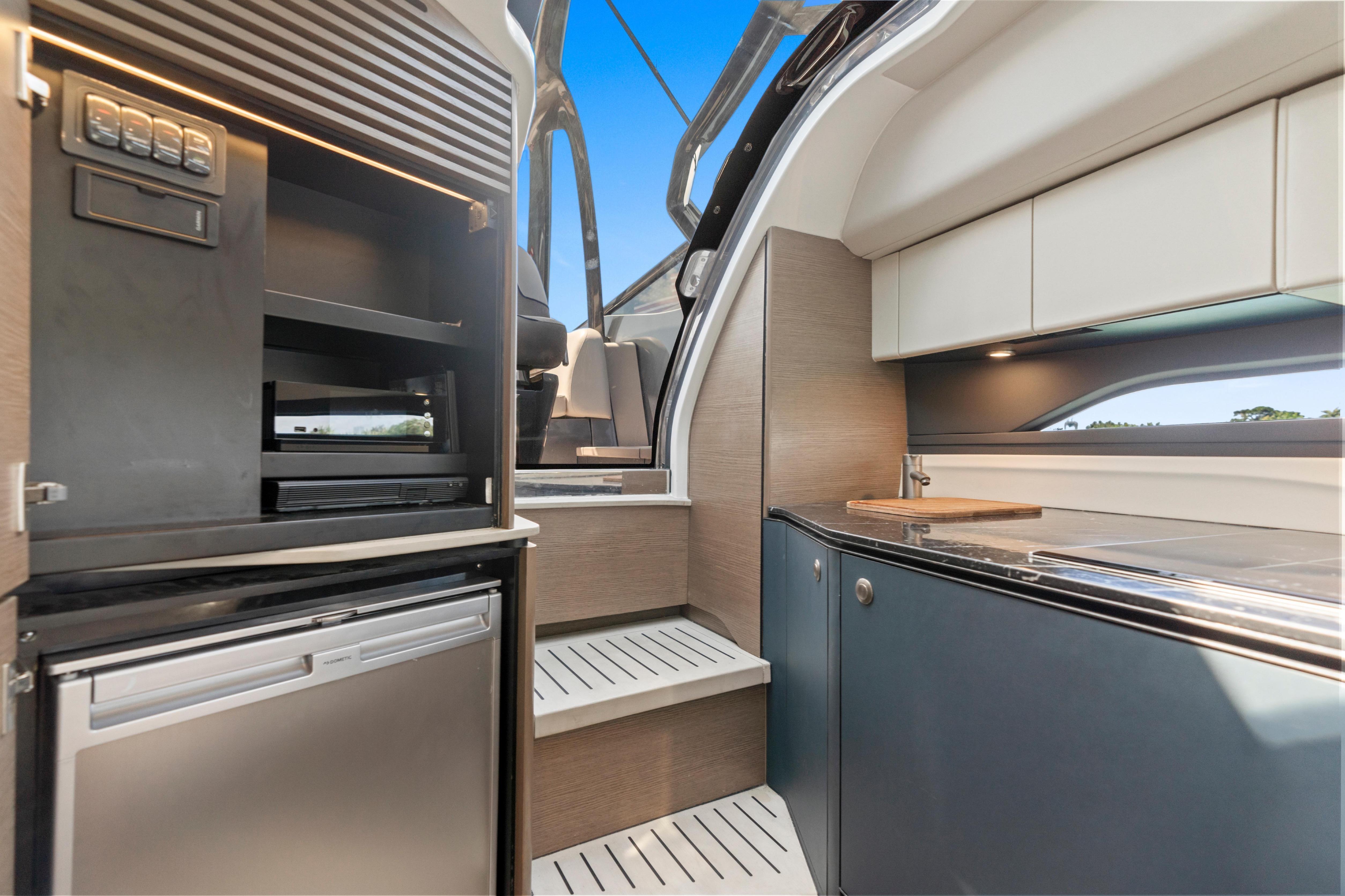 Modern kitchen interior of 2020 Princess R35 yacht, featuring sleek cabinetry and appliances.