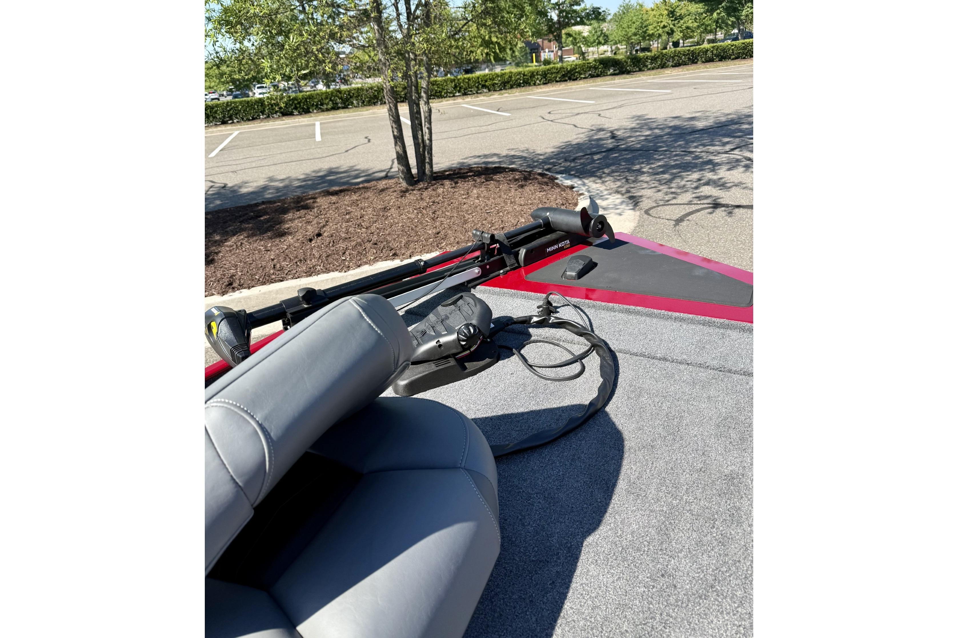 2023 Tracker Bass Tracker Classic XL boat interior with seating and equipment in a parking lot.