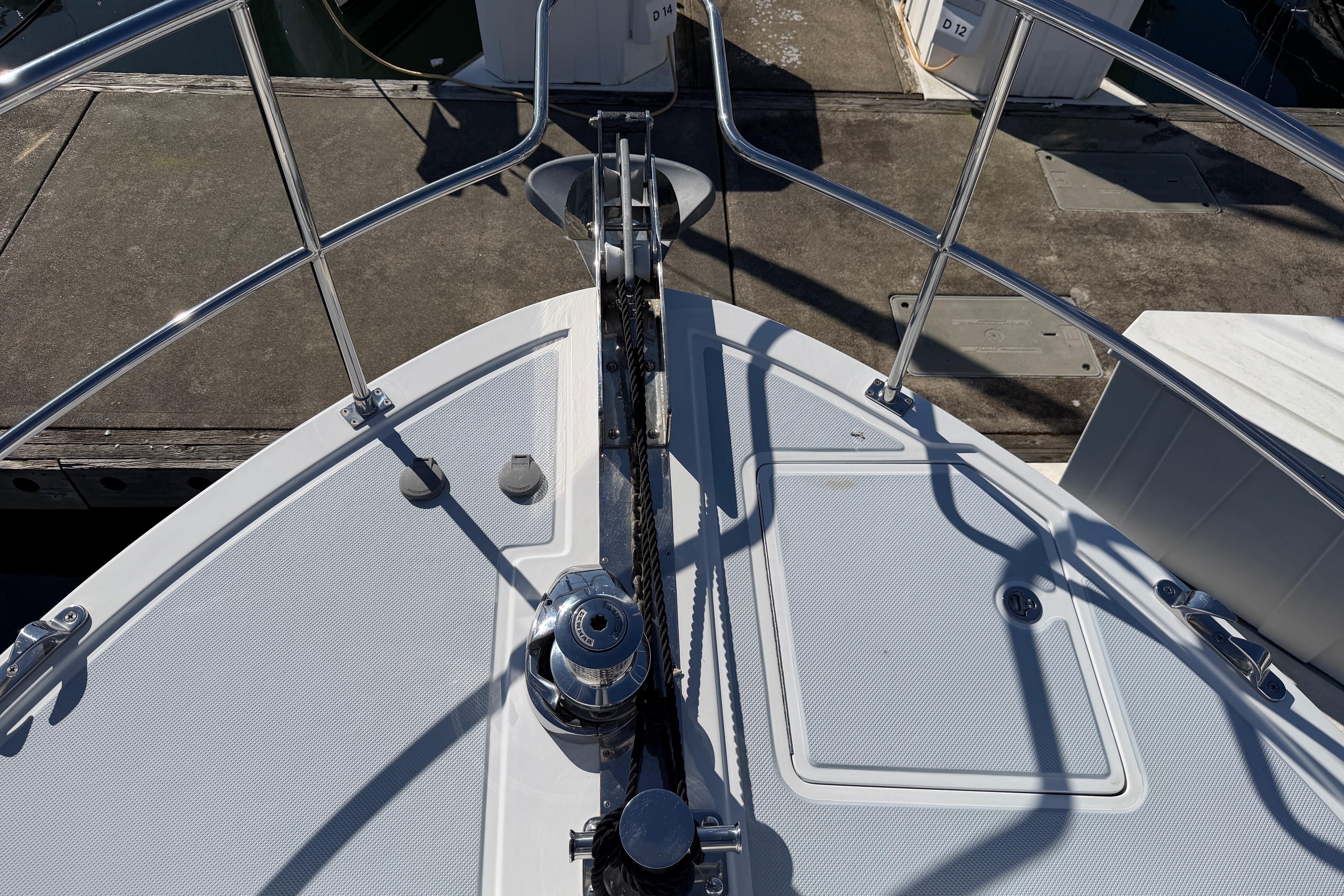 Bow of 2020 Helmsman Trawlers 38E with anchor and railing at dock.