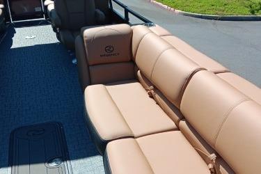 2026 Regency 250 DL boat interior with tan leather seating and carpeted flooring.