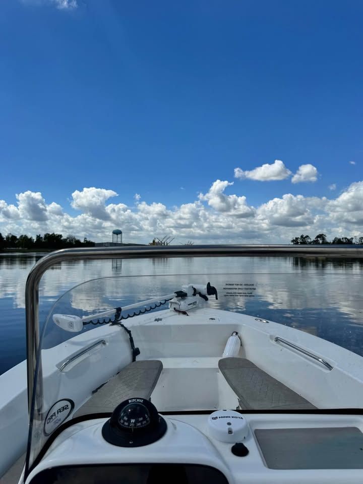 Sea Pro 199 Center Console boat on calm water, blue sky.