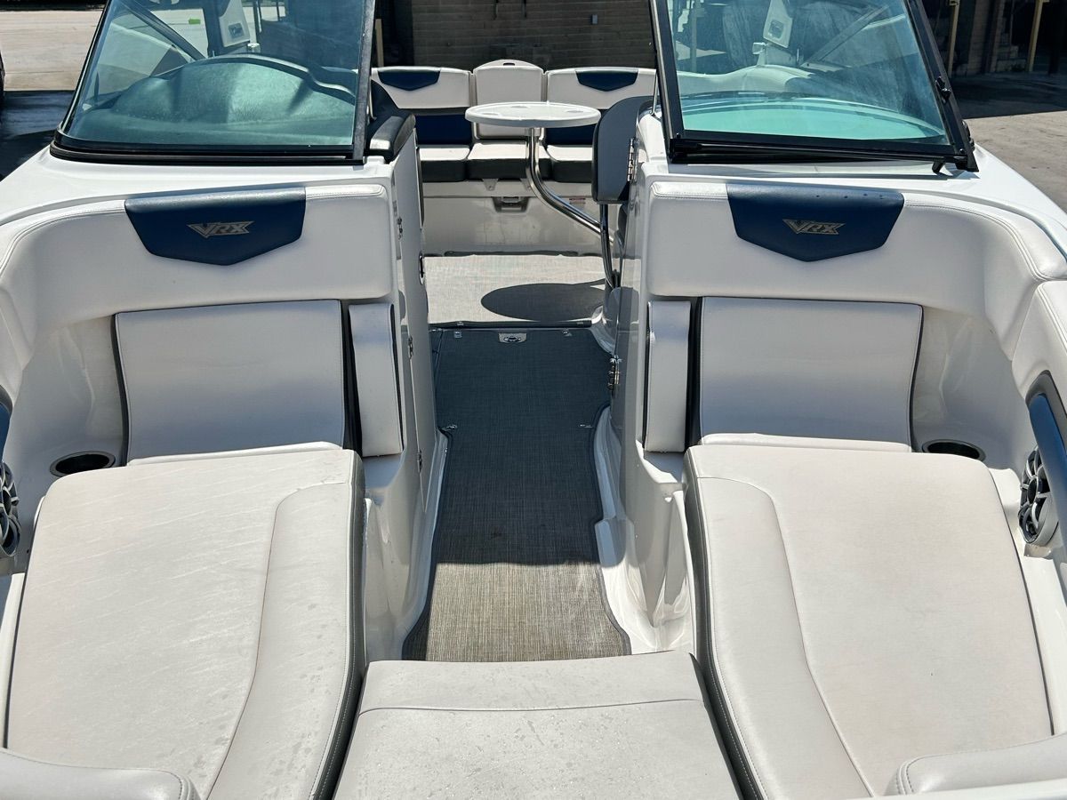 The image shows the cockpit of a 2016 Chaparral Vortex 243 VRX with white seating.