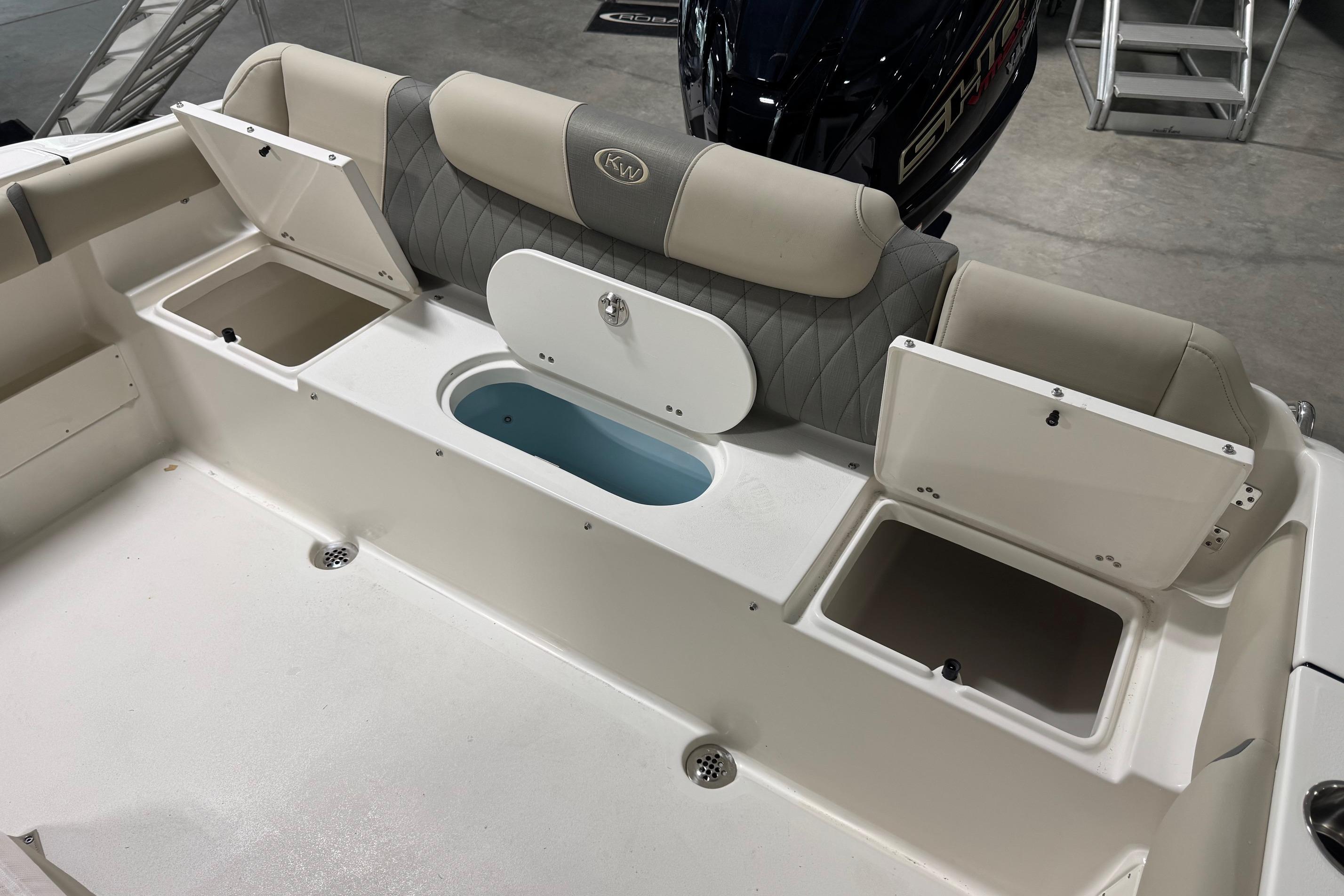 2026 Key West 239 FS boat interior with storage compartments and seating.