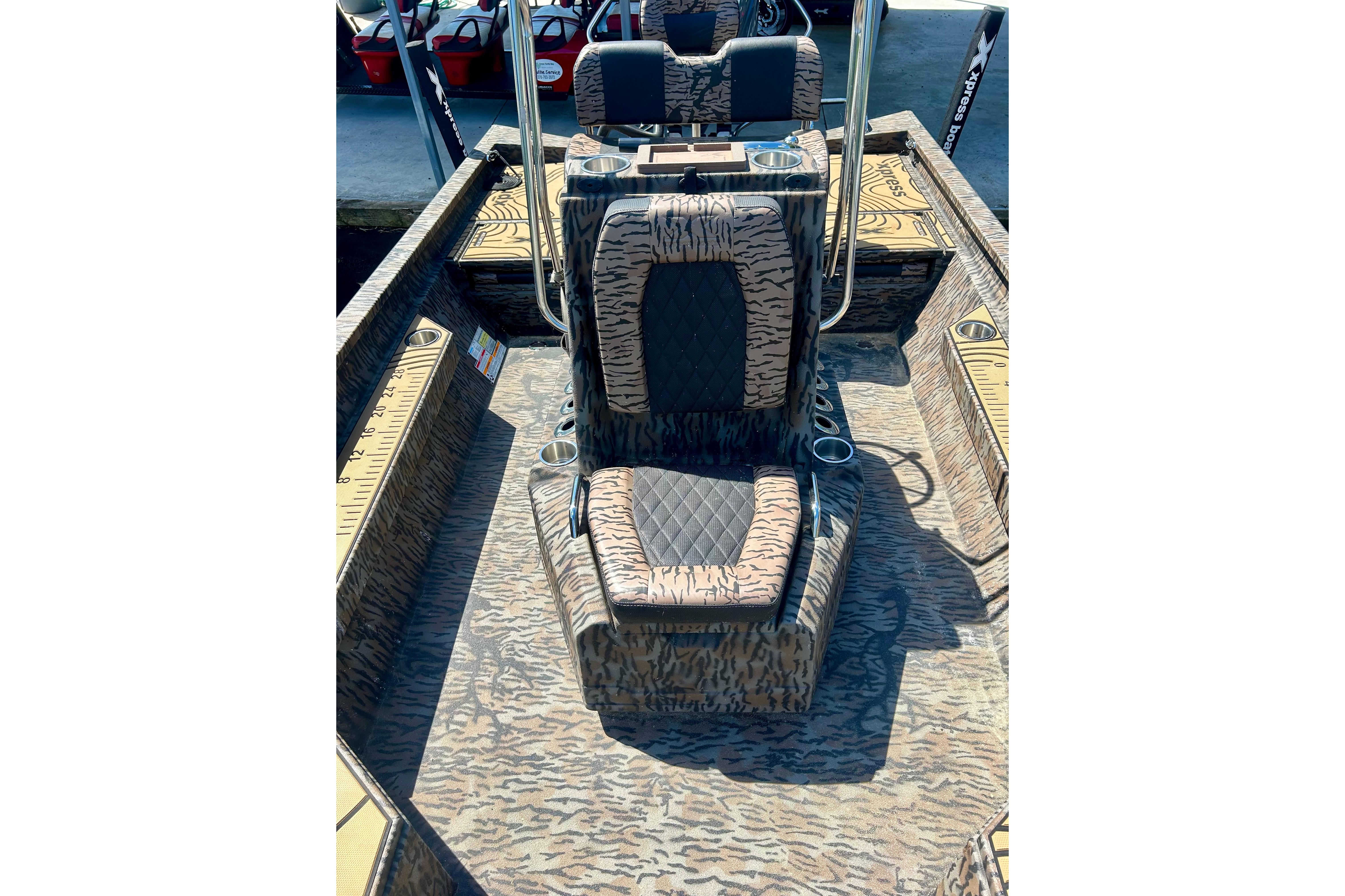 2025 Xpress H22B Bay boat interior with patterned seating and console design.