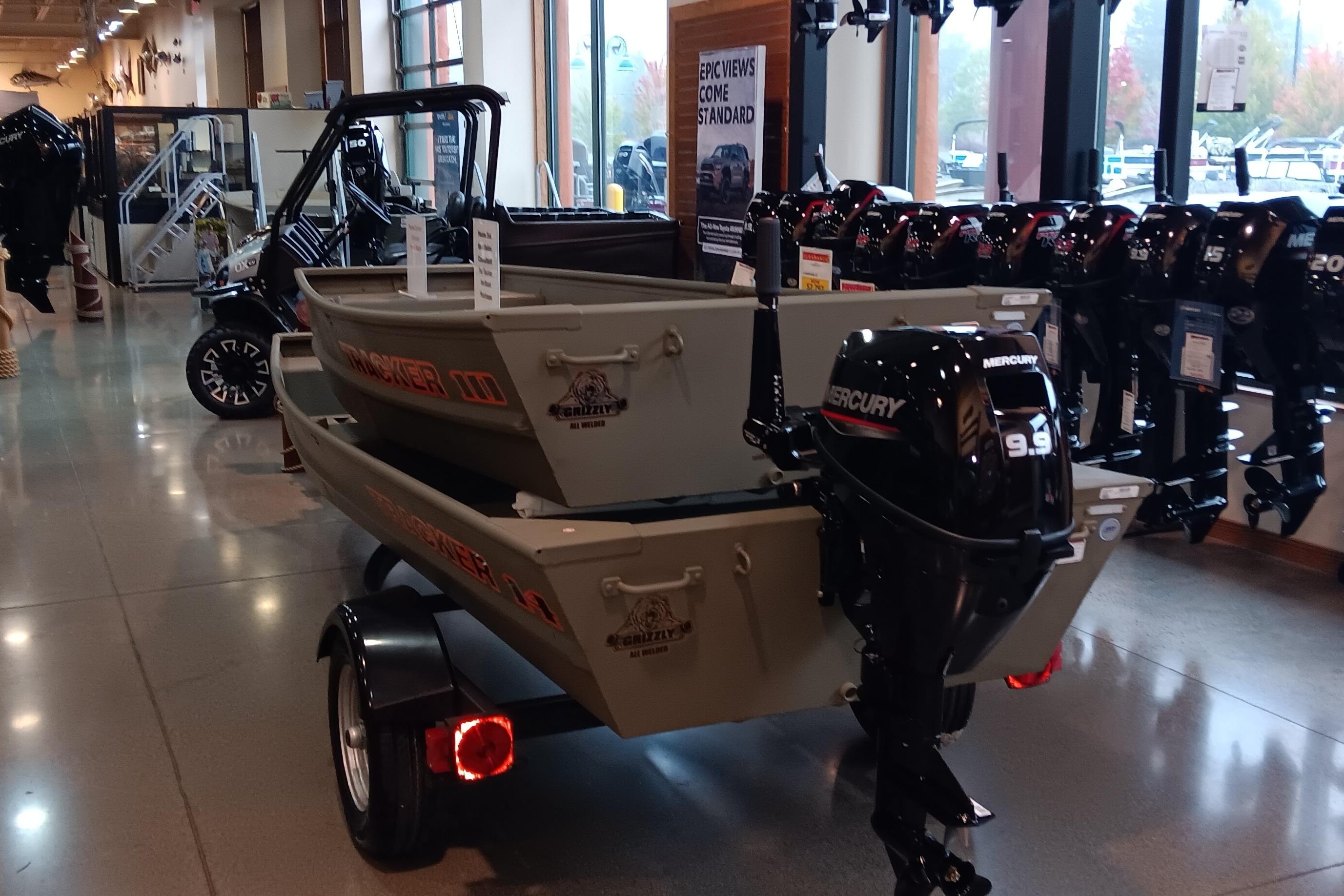 2026 Tracker Grizzly 14 Jon boat with Mercury 9.9 motor in showroom.
