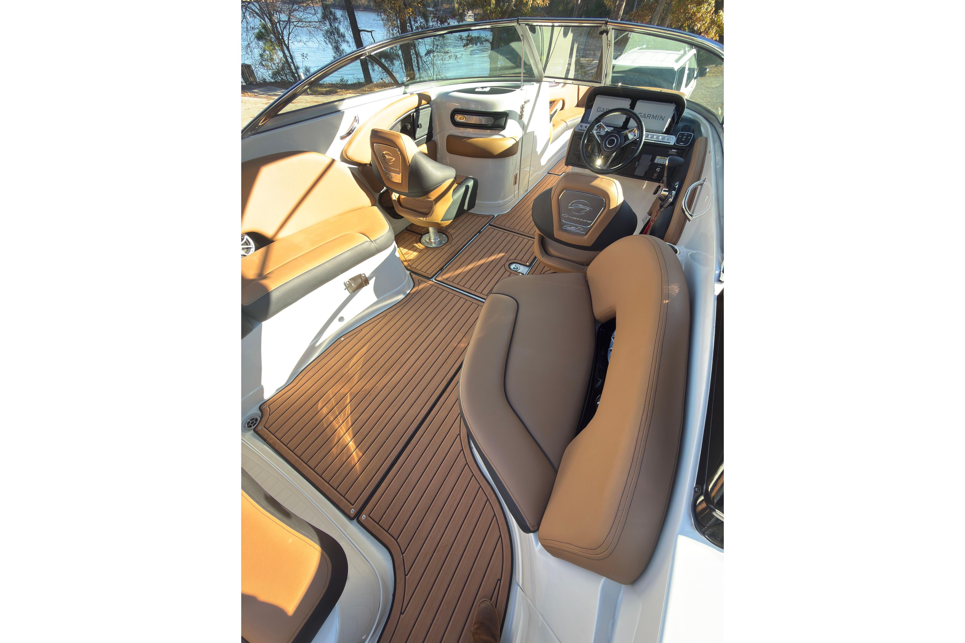 2026 Crownline 298 SS boat interior with tan leather seats and wood-style flooring.