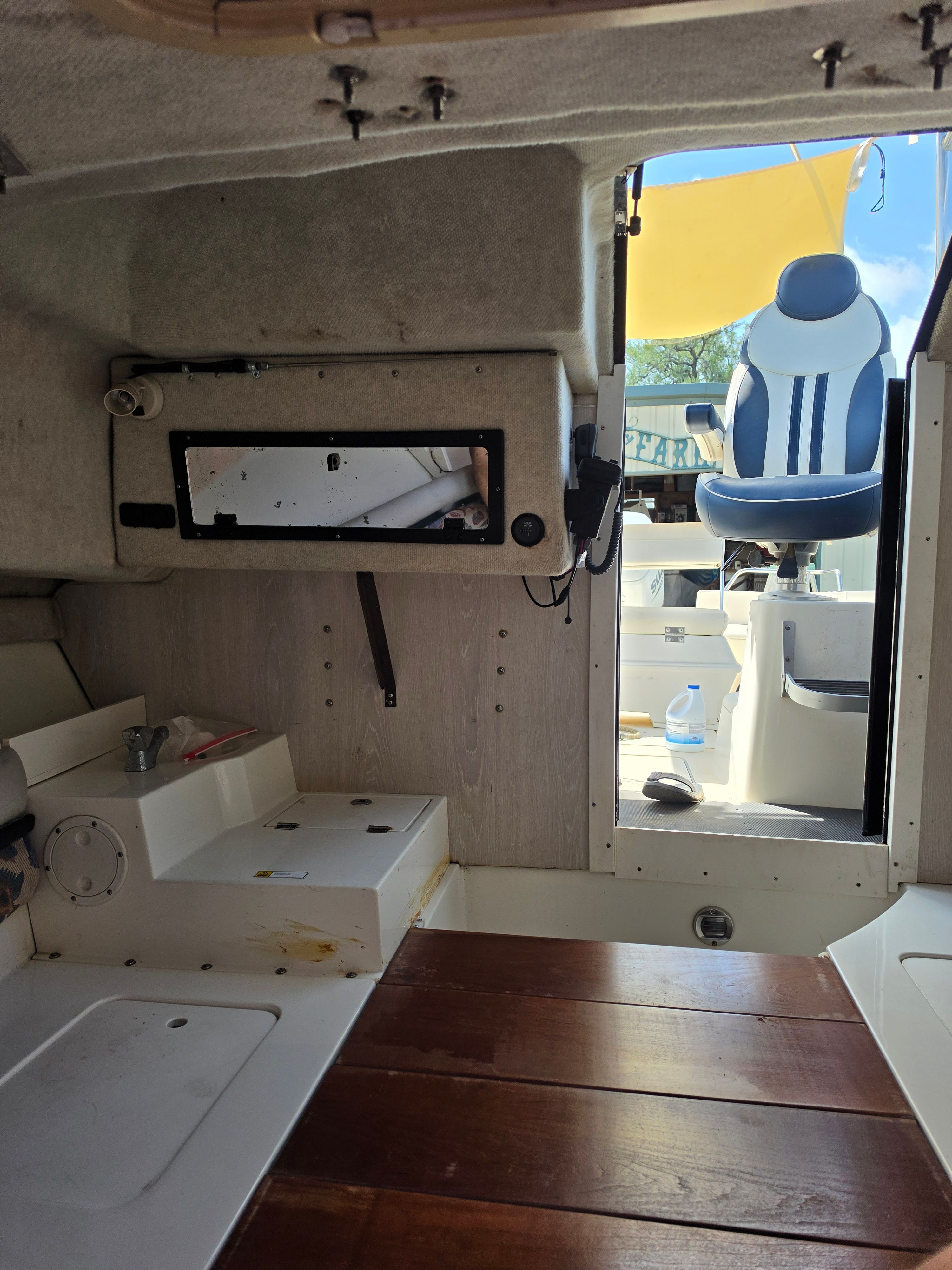 Interior of a 1998 Hydra-Sports 2450 with wooden flooring and view of the cockpit.