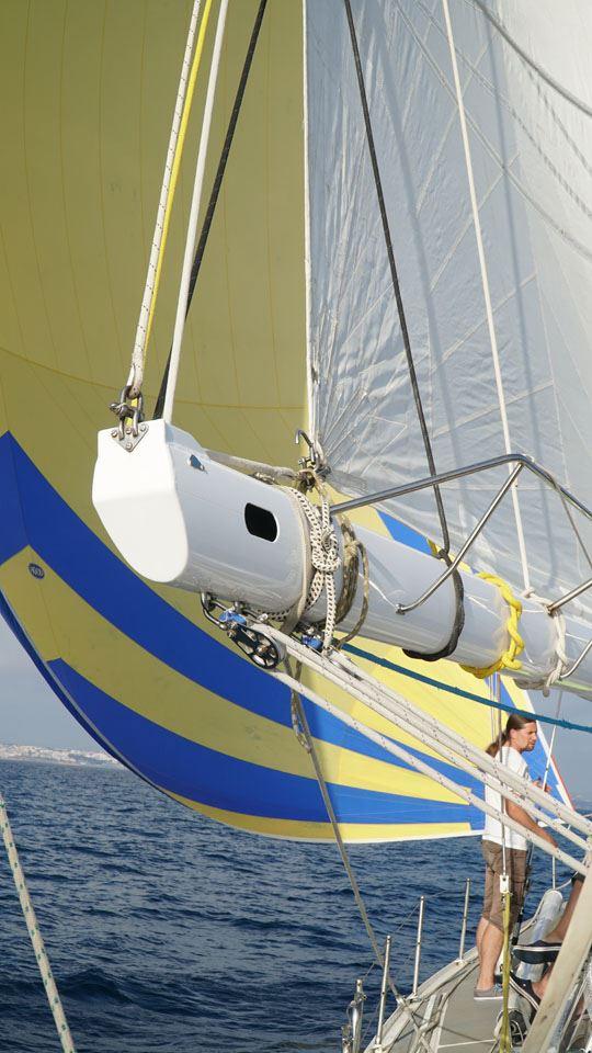 Sailing yacht Devonport Challenge 67, 1995 model, with vibrant yellow and blue sails.