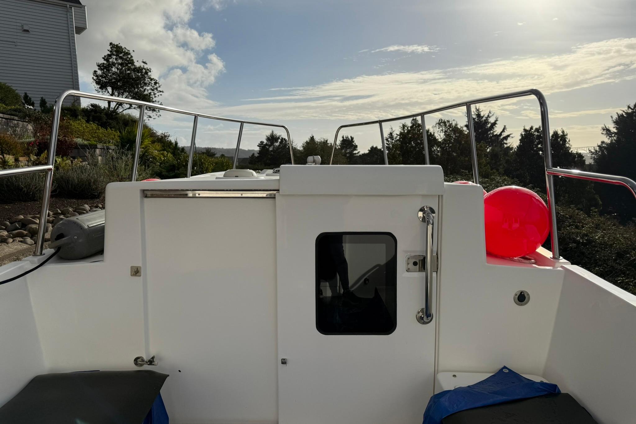 2020 SeaPiper 35 boat deck with railing, red buoy, and scenic background.