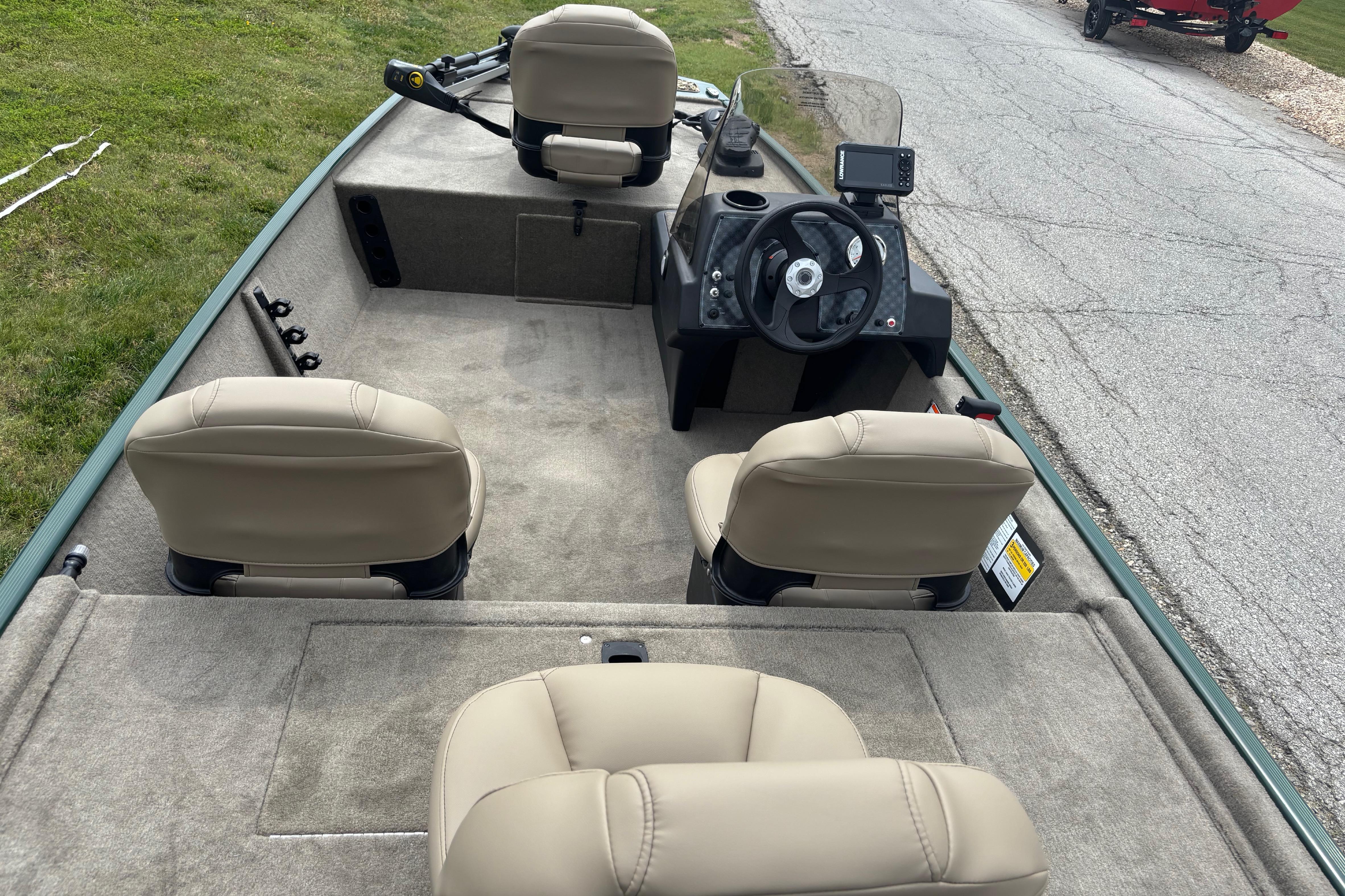 2026 Tracker Bass Tracker Classic Limited boat interior with beige seats and steering console.