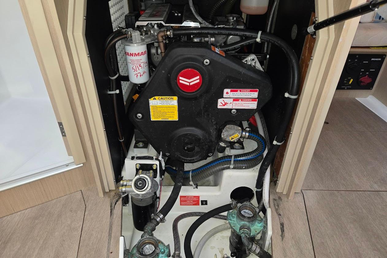Engine compartment of 2023 Beneteau Oceanis 38.1 sailboat, featuring Yanmar engine components.