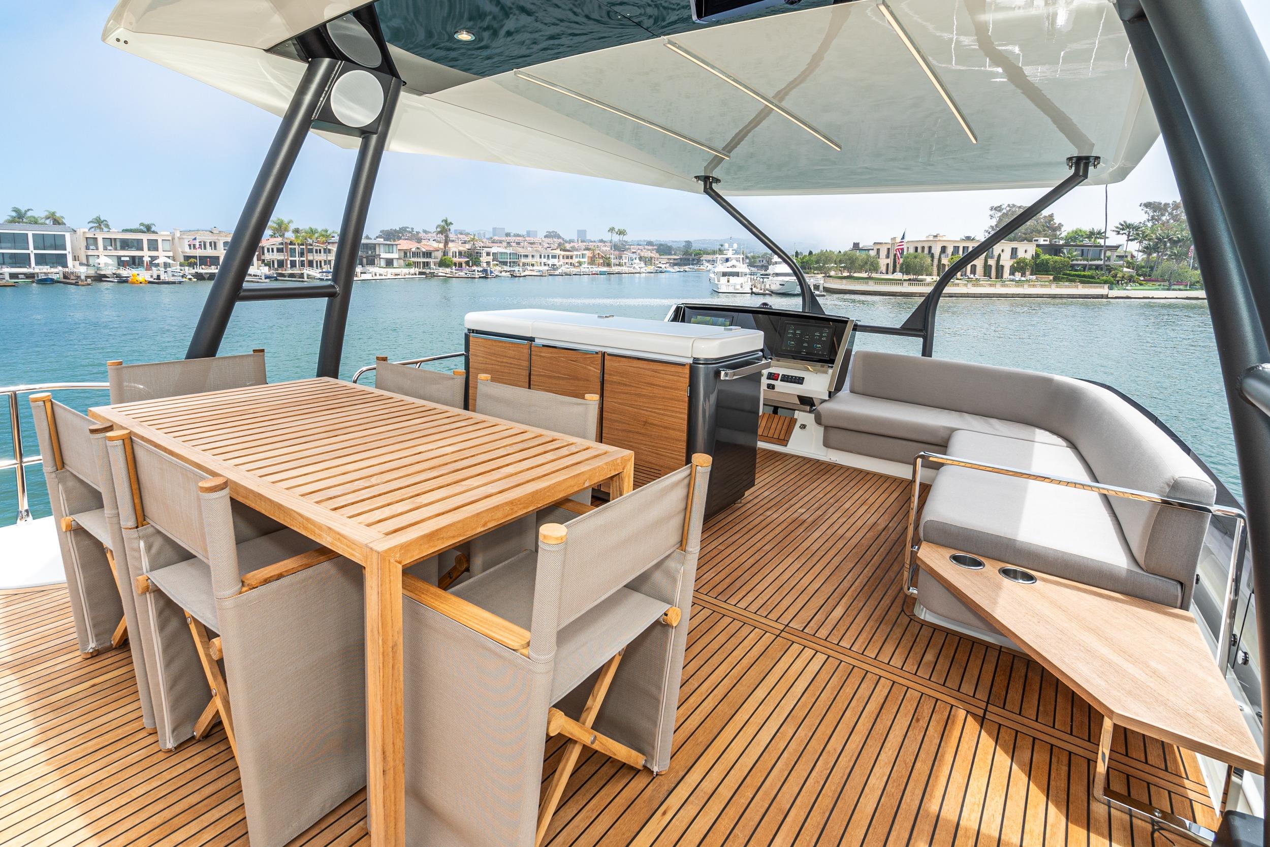 Luxurious 2024 Prestige X60 yacht deck with elegant seating and dining area.