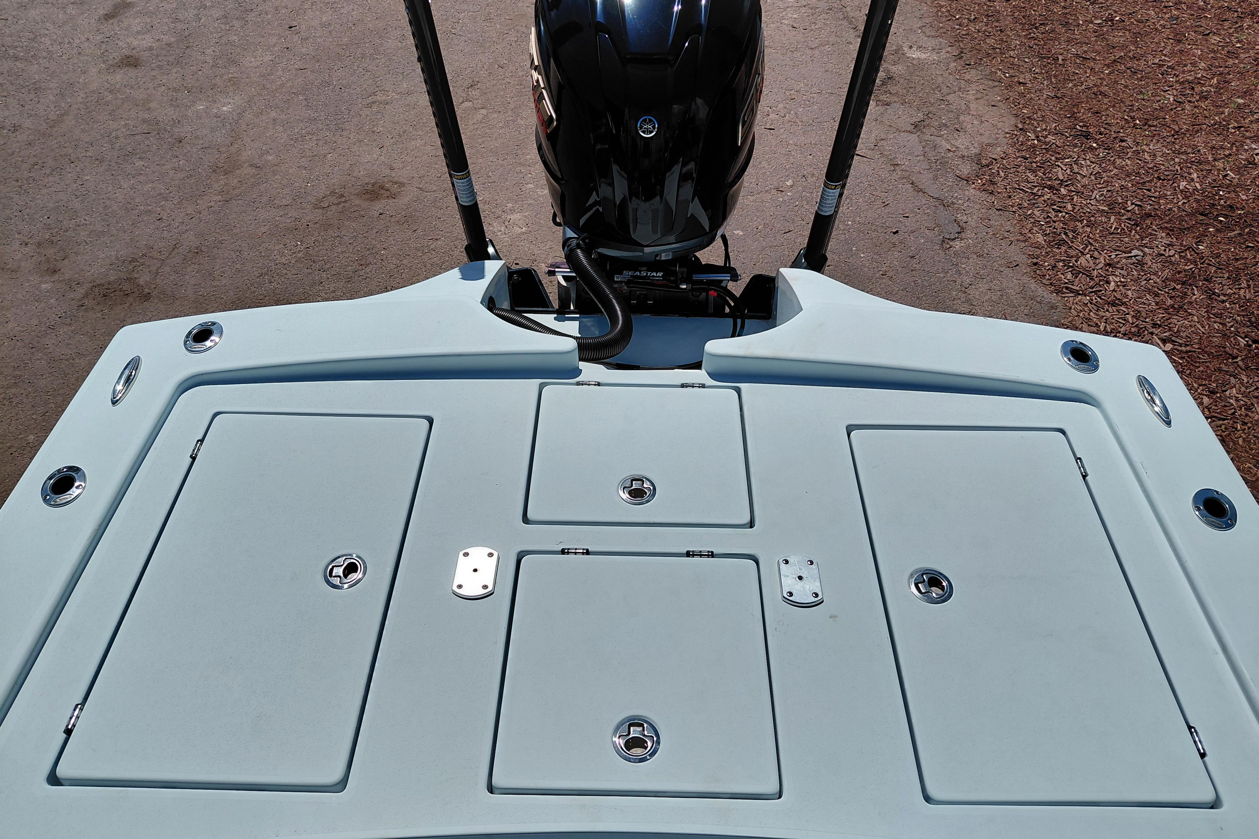2022 Pathfinder 2300 HPS boat deck with storage compartments and motor.
