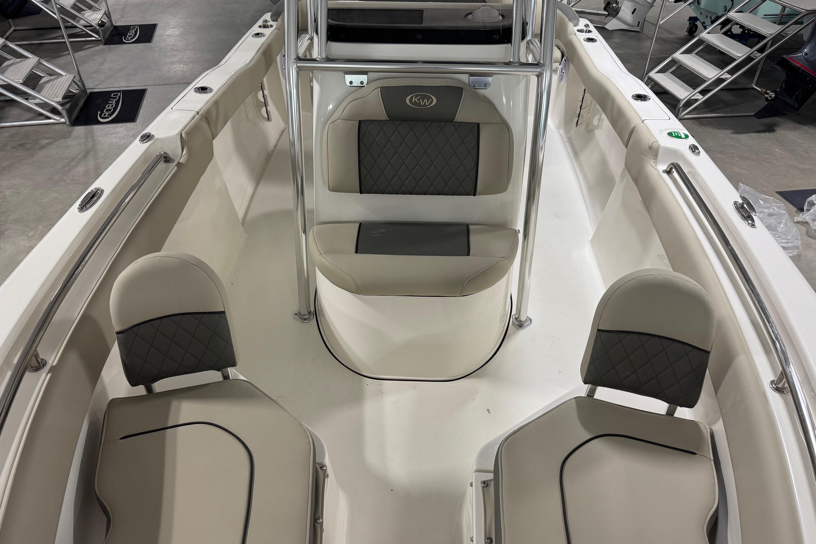 2026 Key West 203 FS boat interior with cushioned seating and stainless steel railings.