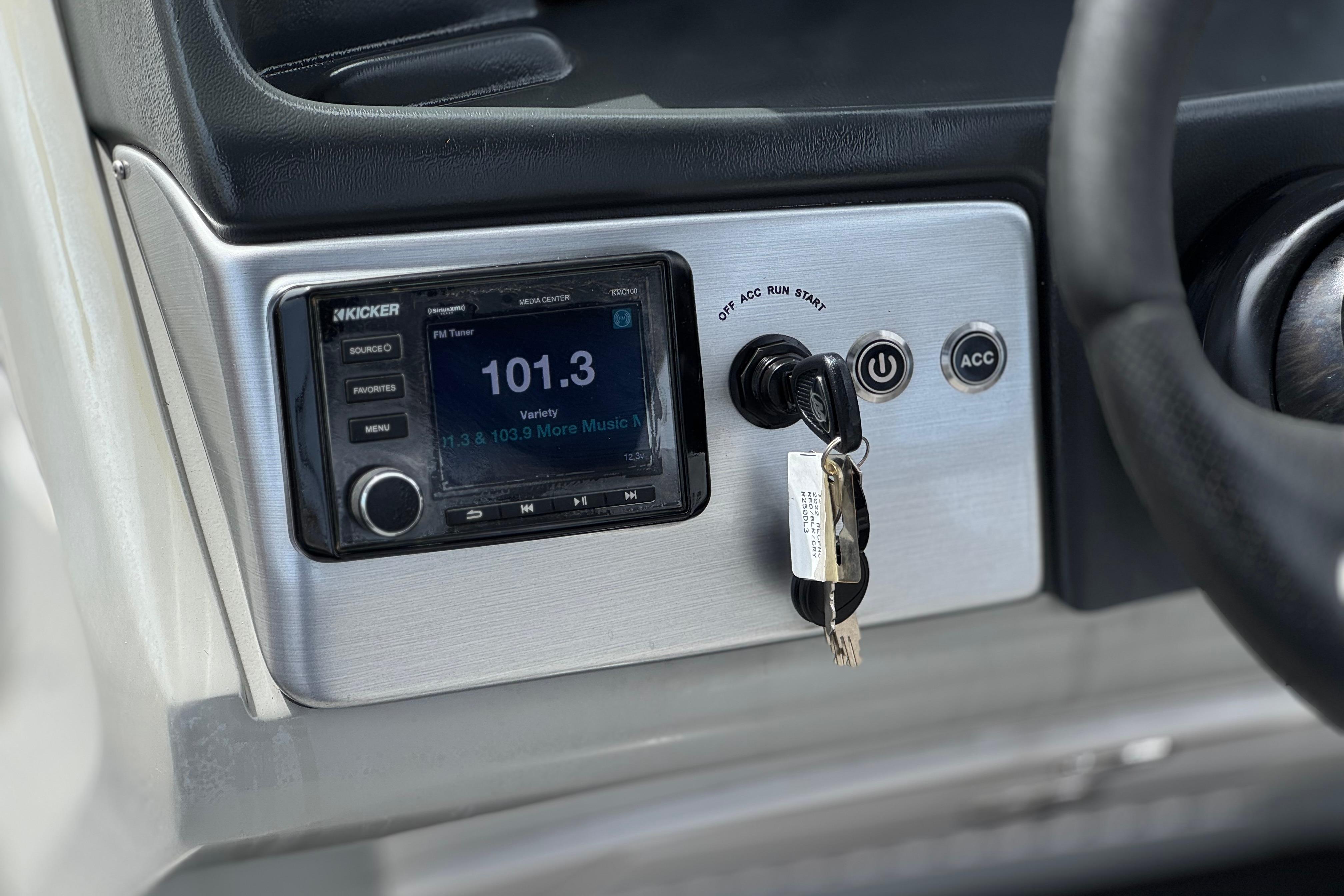 Dashboard of a 2022 Regency 250 DL3 with Kicker media center and ignition keys.