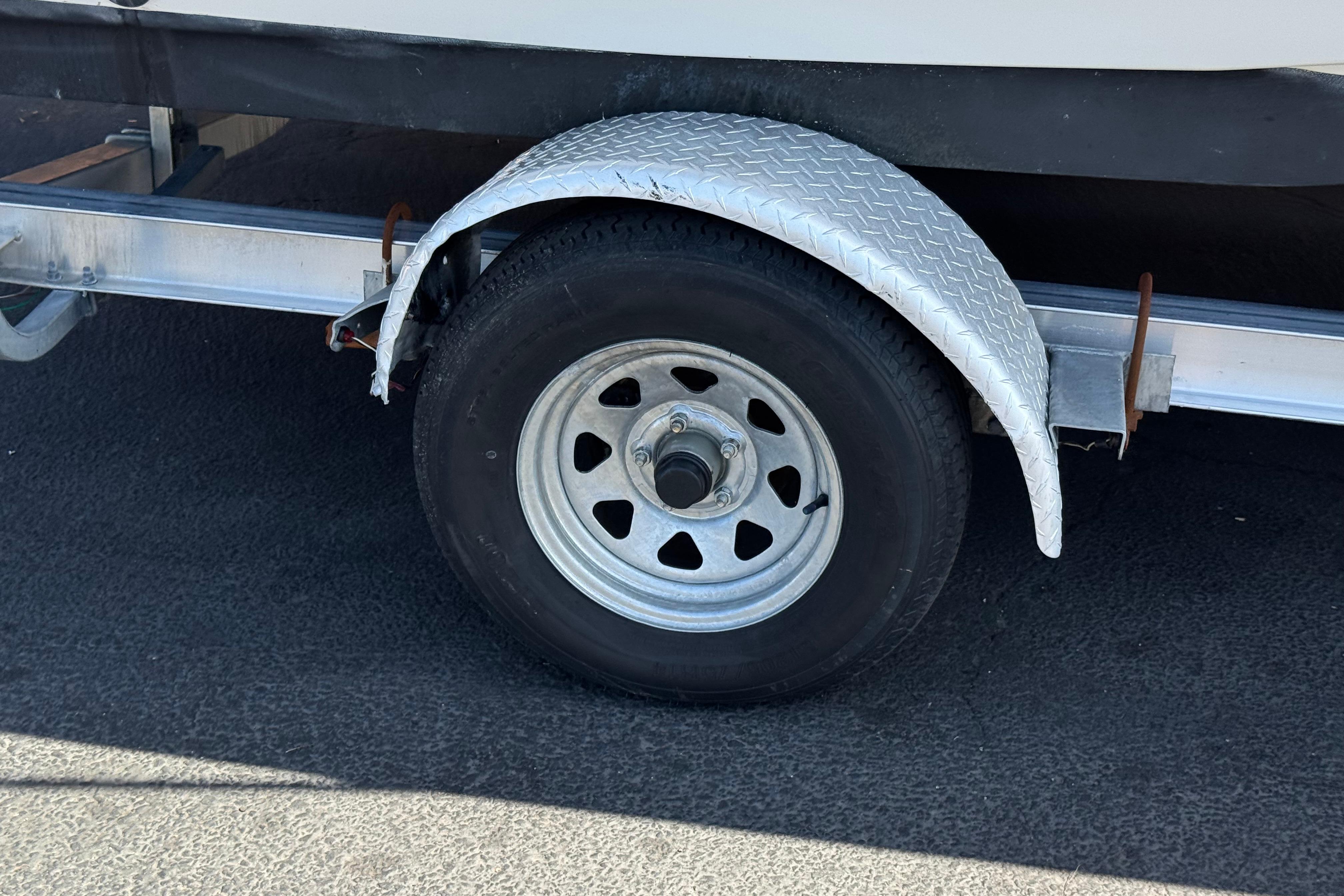 Trailer wheel and fender of a 2020 NauticStar 203 SC boat.