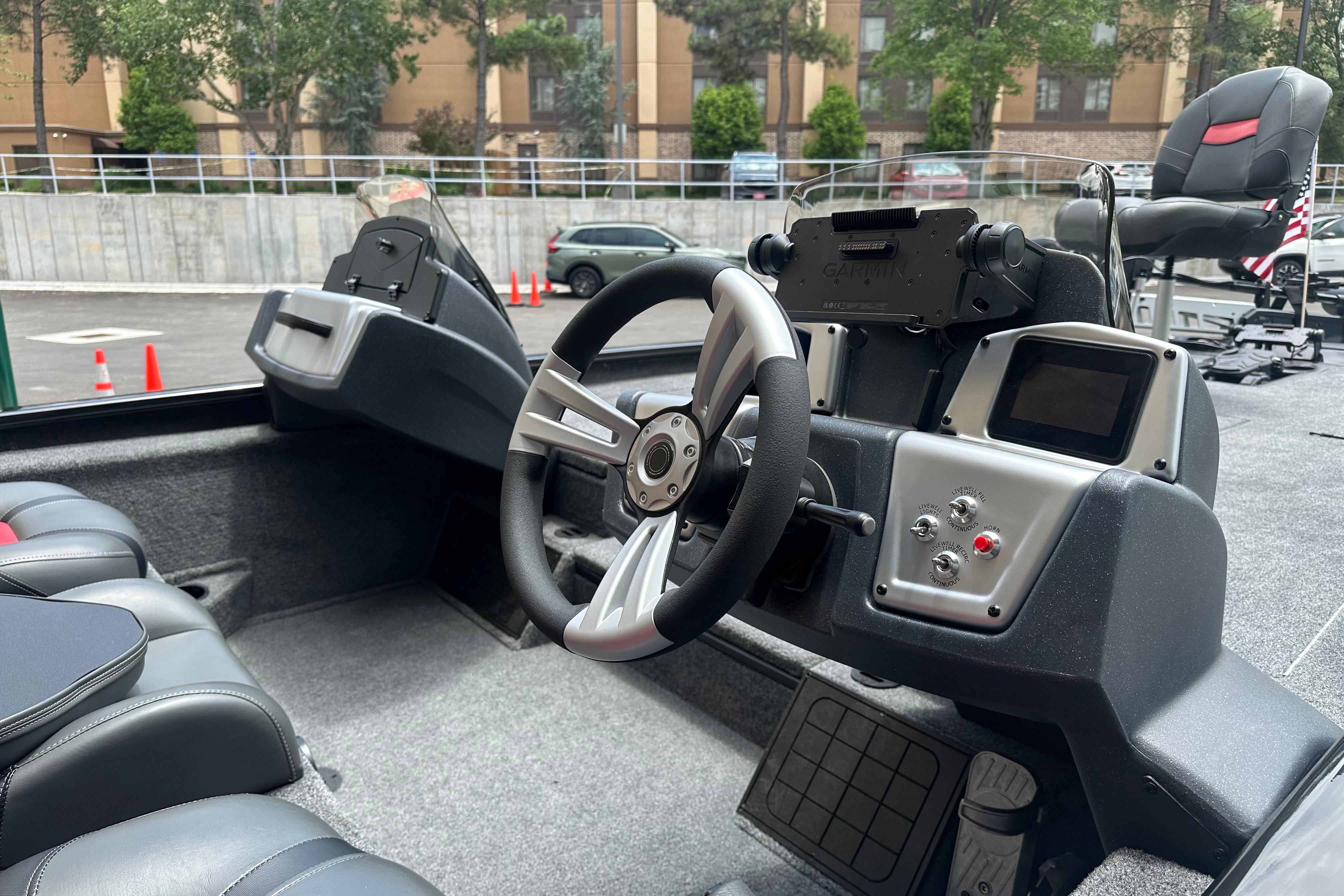 Interior view of 2025 Tracker Savage 215 boat, featuring steering wheel and control panel.