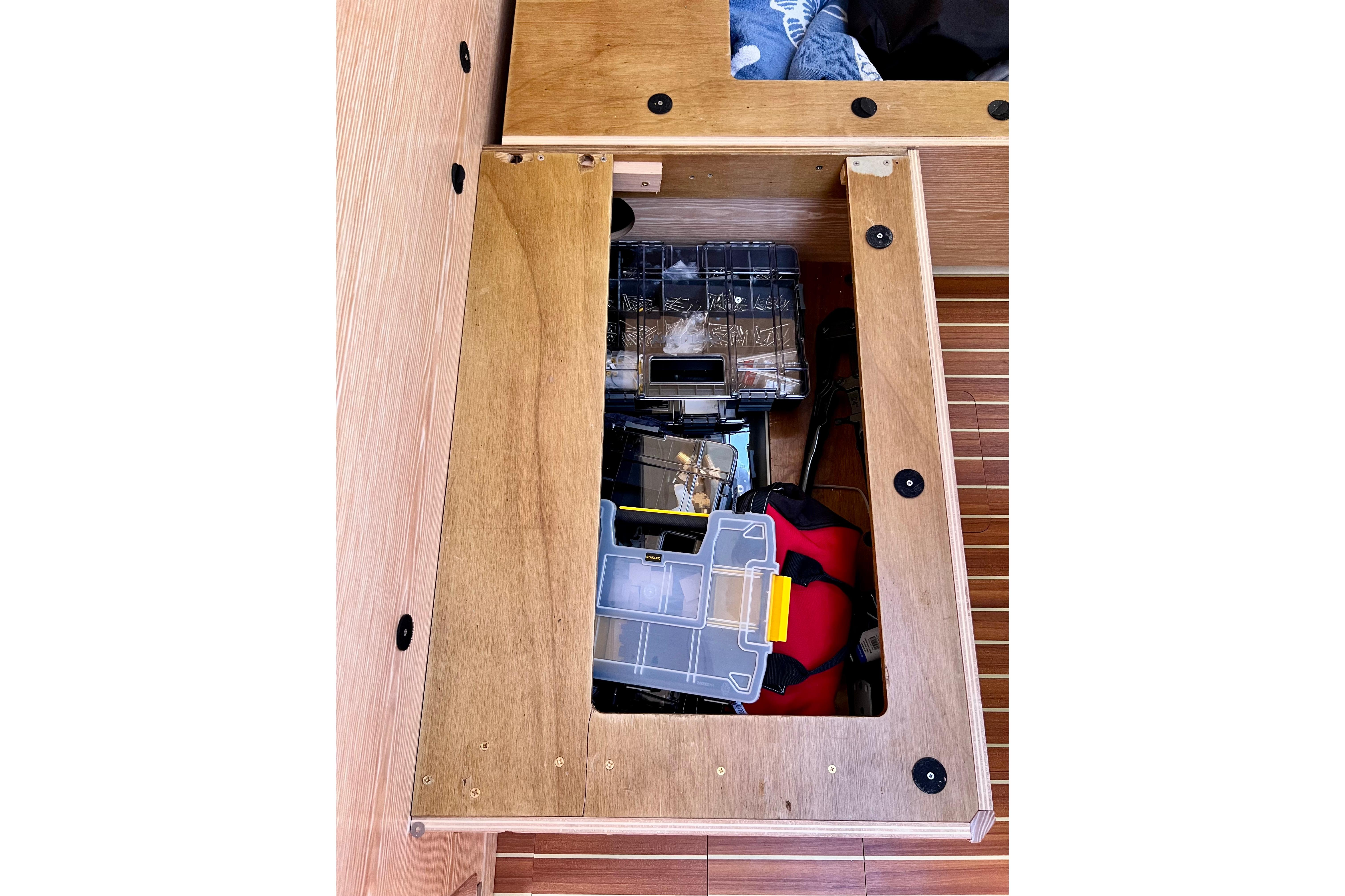 Storage compartment on a 2016 Hanse 455 yacht, containing various tools and equipment.