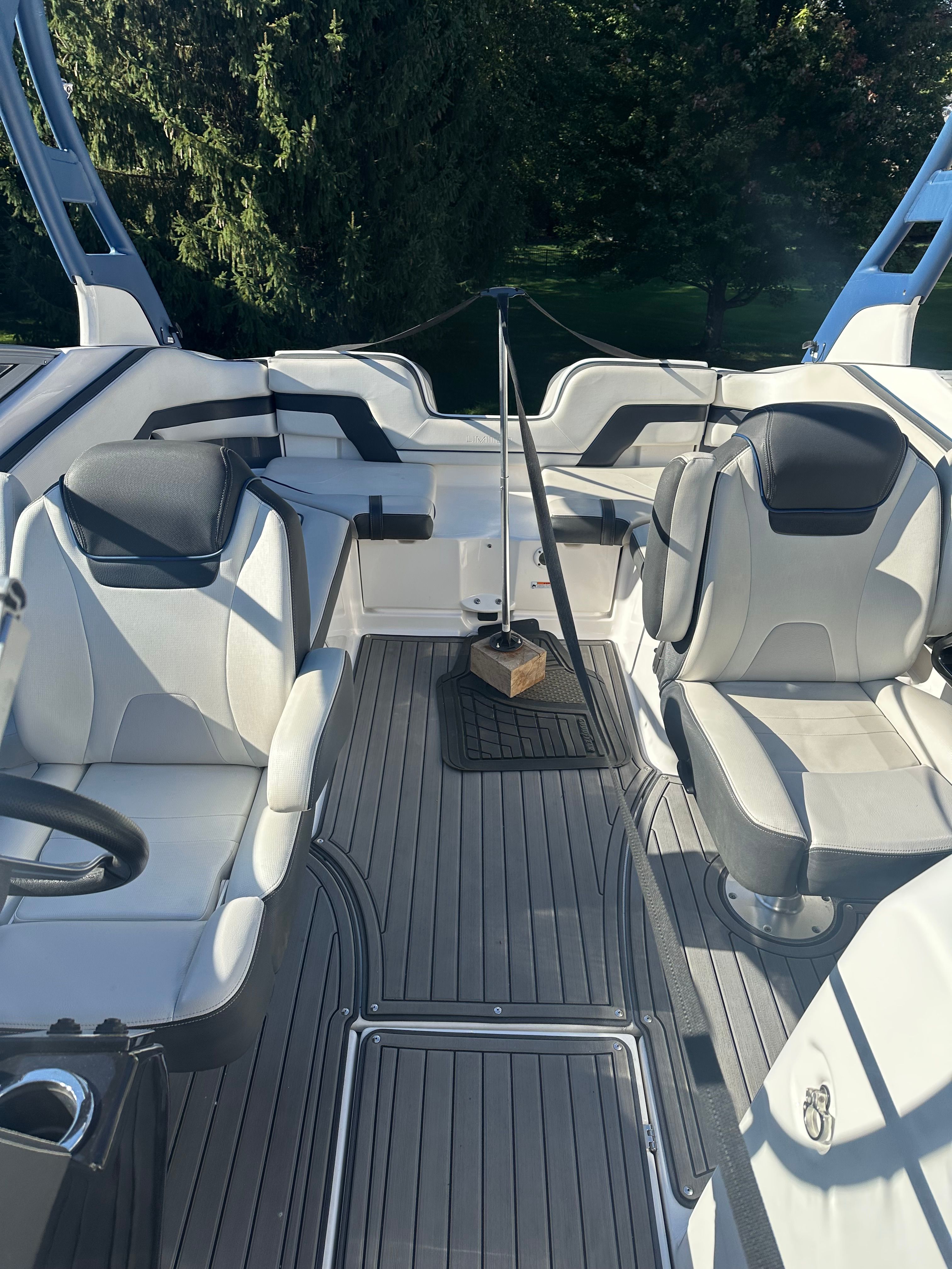 The image shows the cockpit of a 2018 Yamaha 242 Limited S boat with sleek seating.