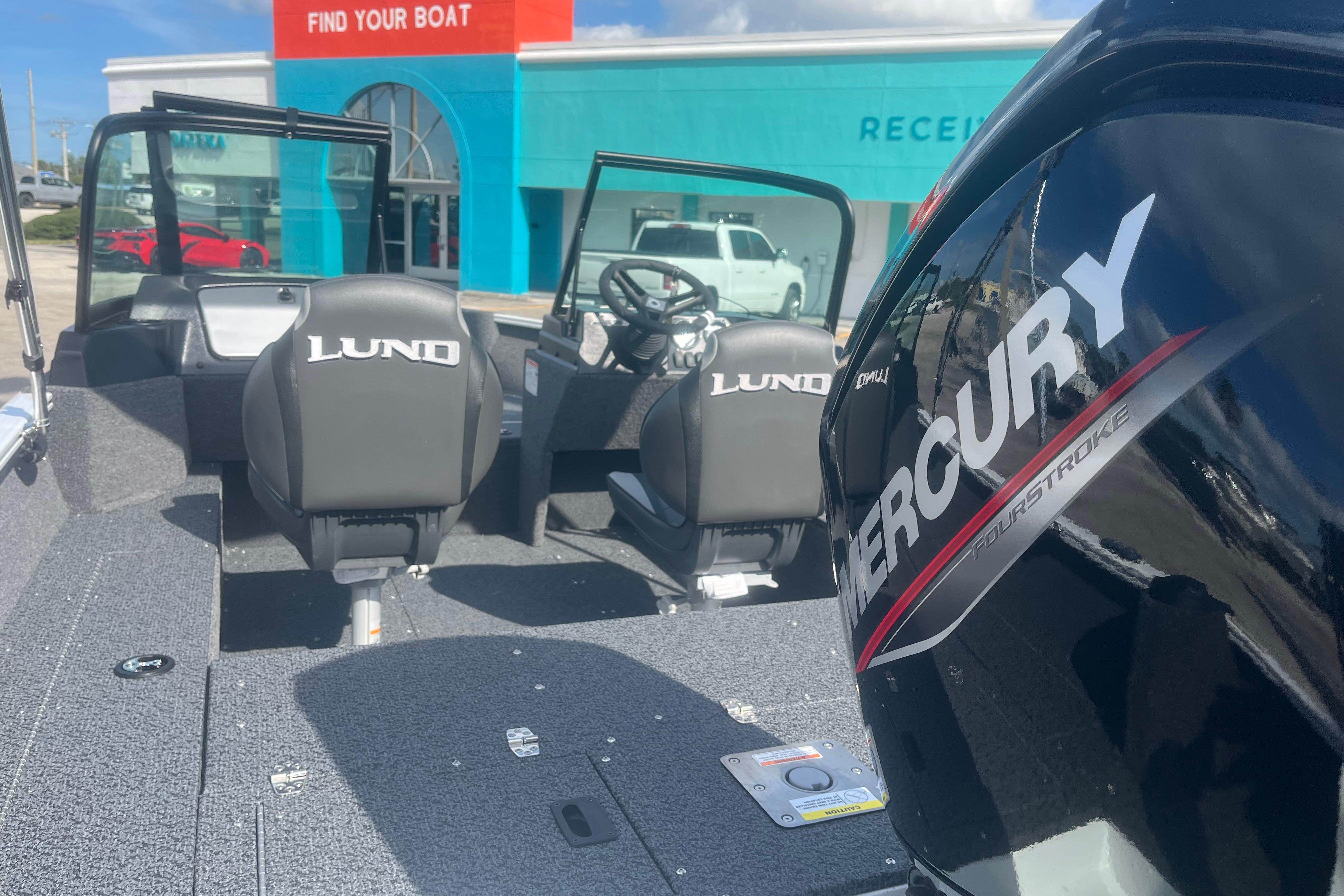 2026 Lund 1650 Rebel XL Sport boat with Mercury engine at dealership.
