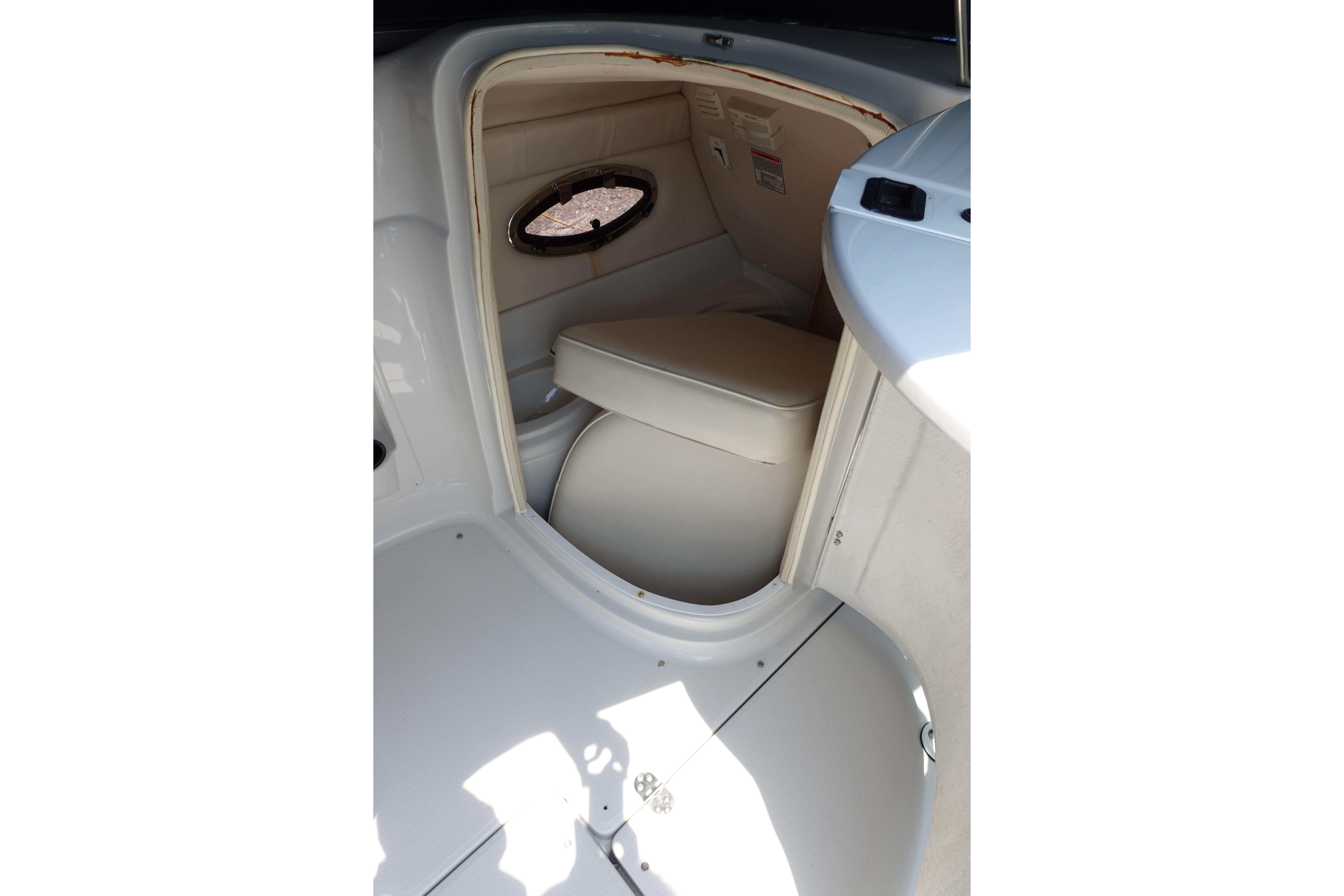 2004 Crownline 240 EX boat interior with seating and porthole window.
