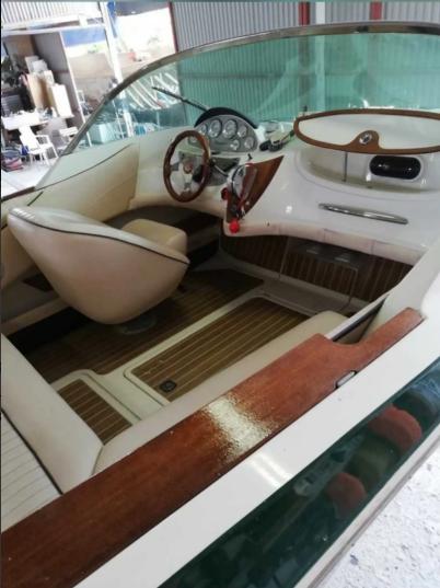 2006 Quicksilver Classic 20 boat interior with wooden accents and steering wheel.