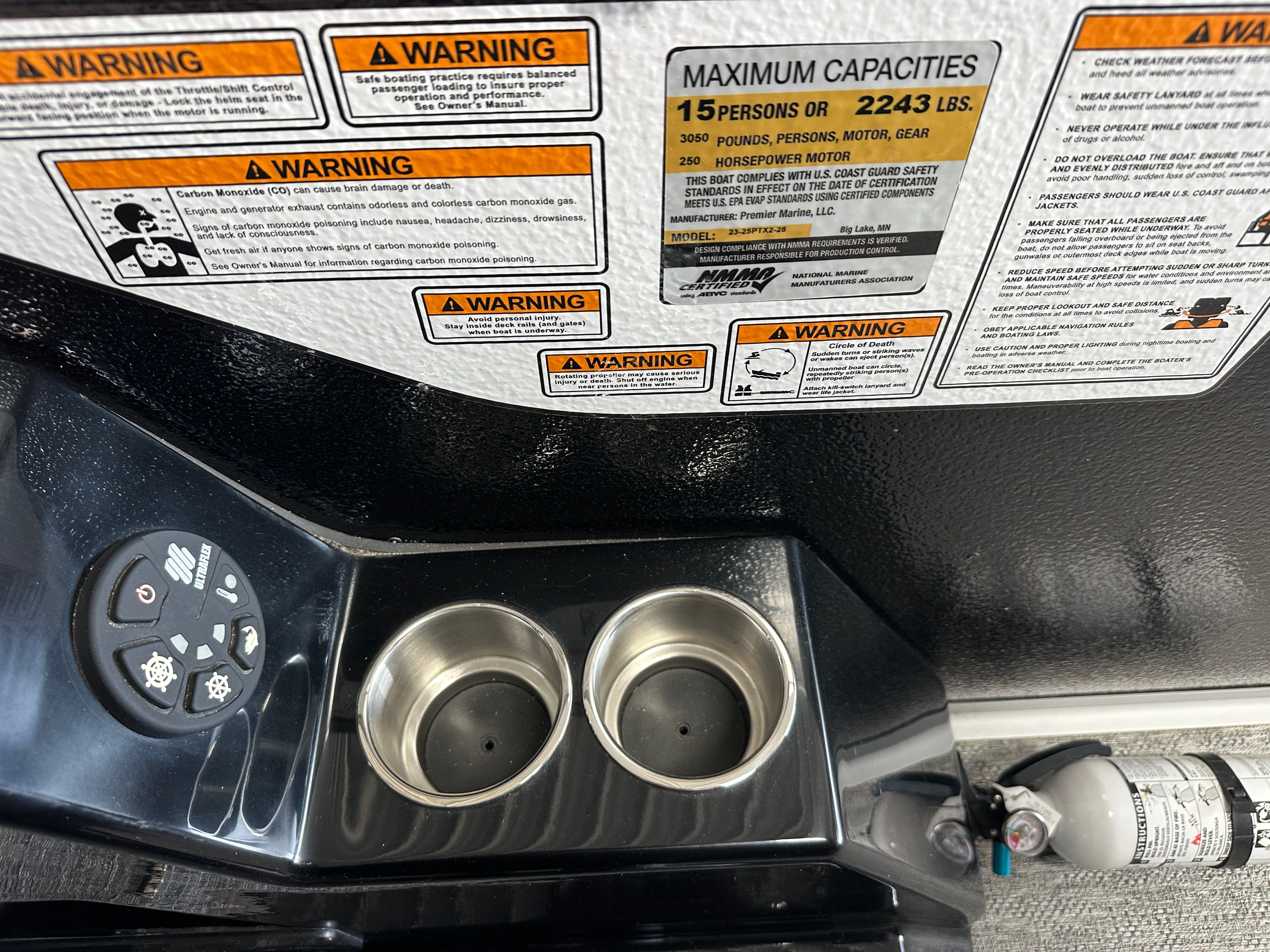 Warning labels and capacity details on a 2024 Premier 230 Sunsation TRITOON.