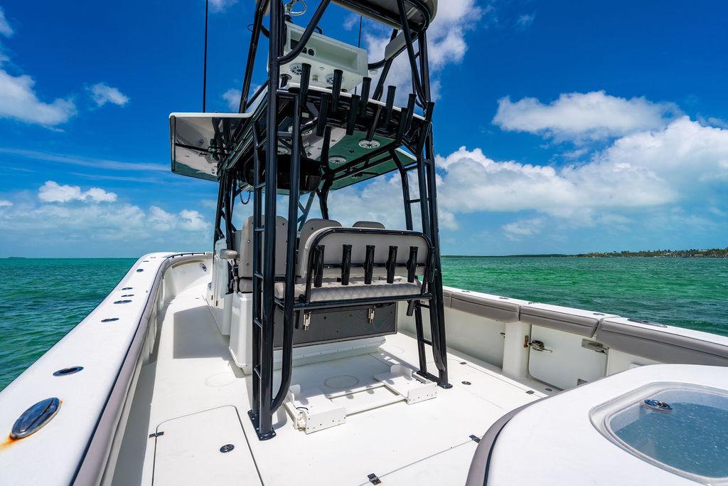 2015 Yellowfin CC boat on turquoise water under clear blue sky.