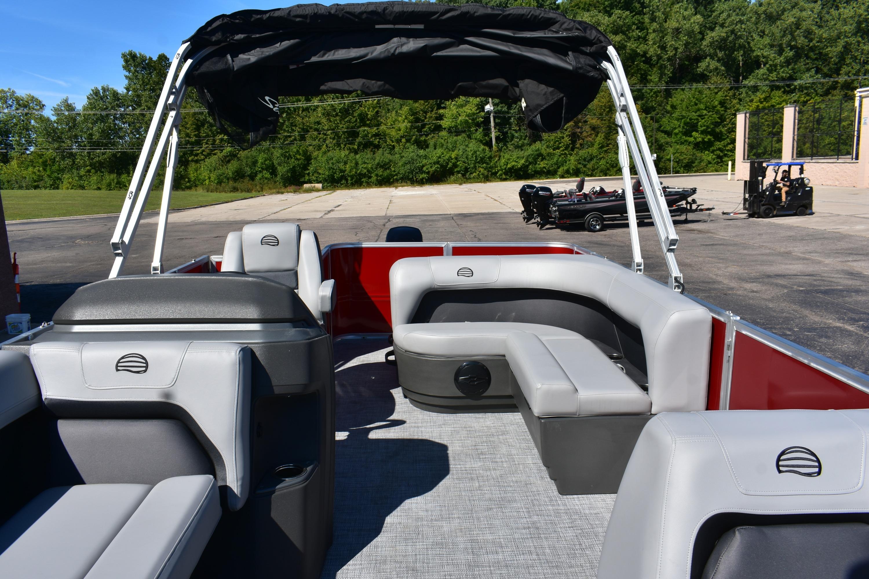 2026 Sun Tracker Party Barge 18 DLX pontoon boat with gray seating and canopy.