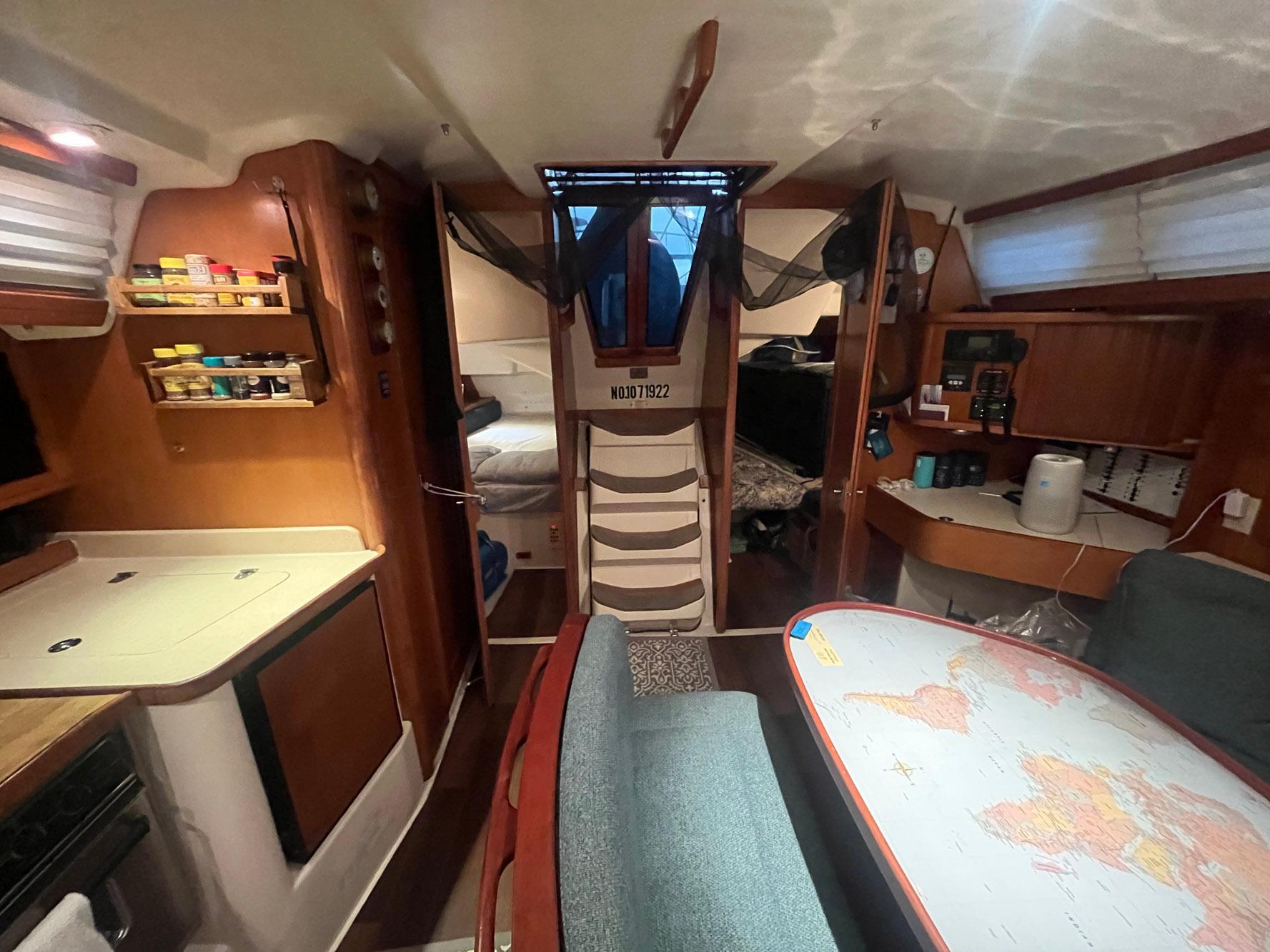 Interior of a 1999 Catalina 42 MkII sailboat with cozy living space and navigation table.