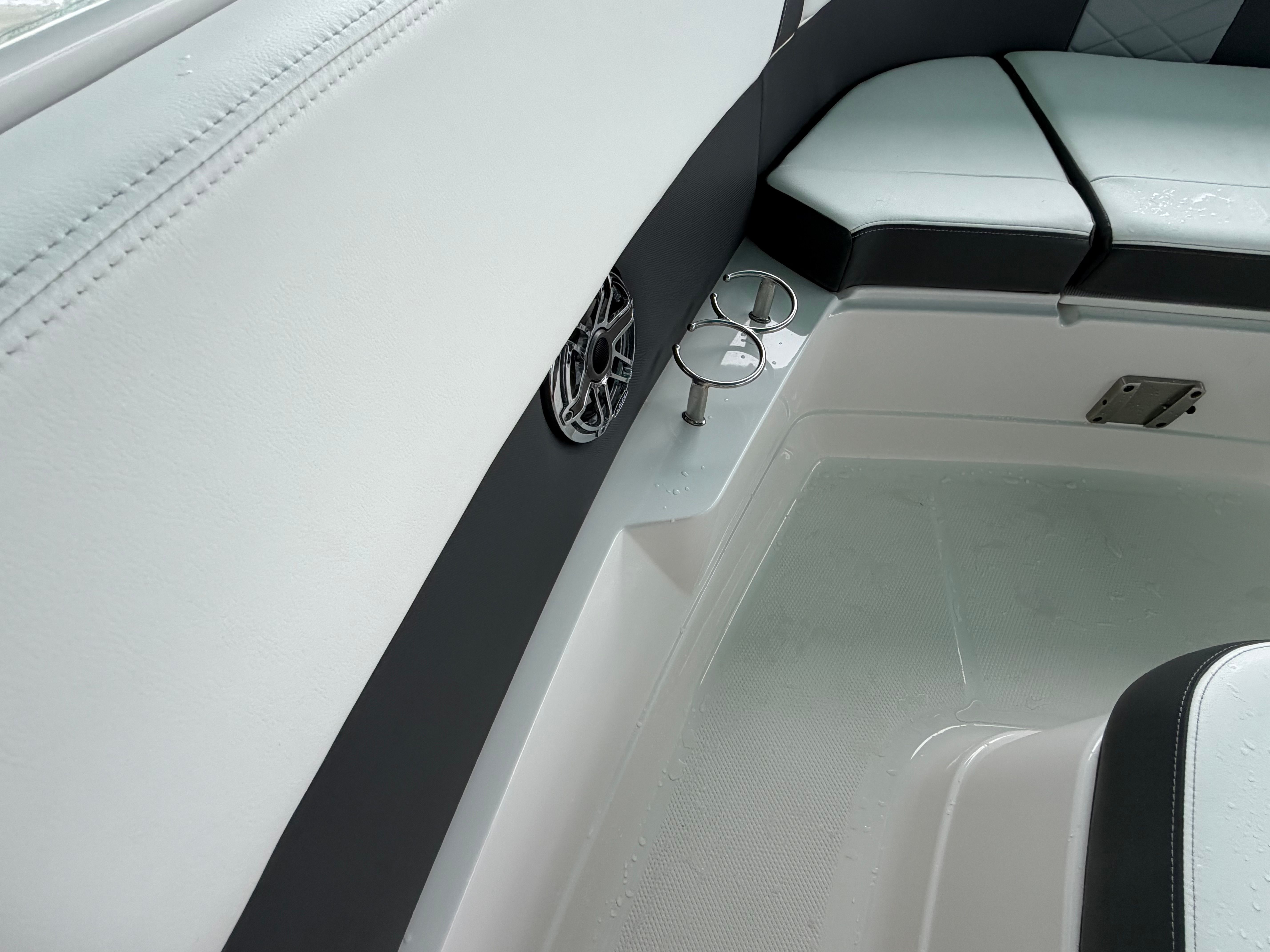 Interior of a modern boat with white and black seating.