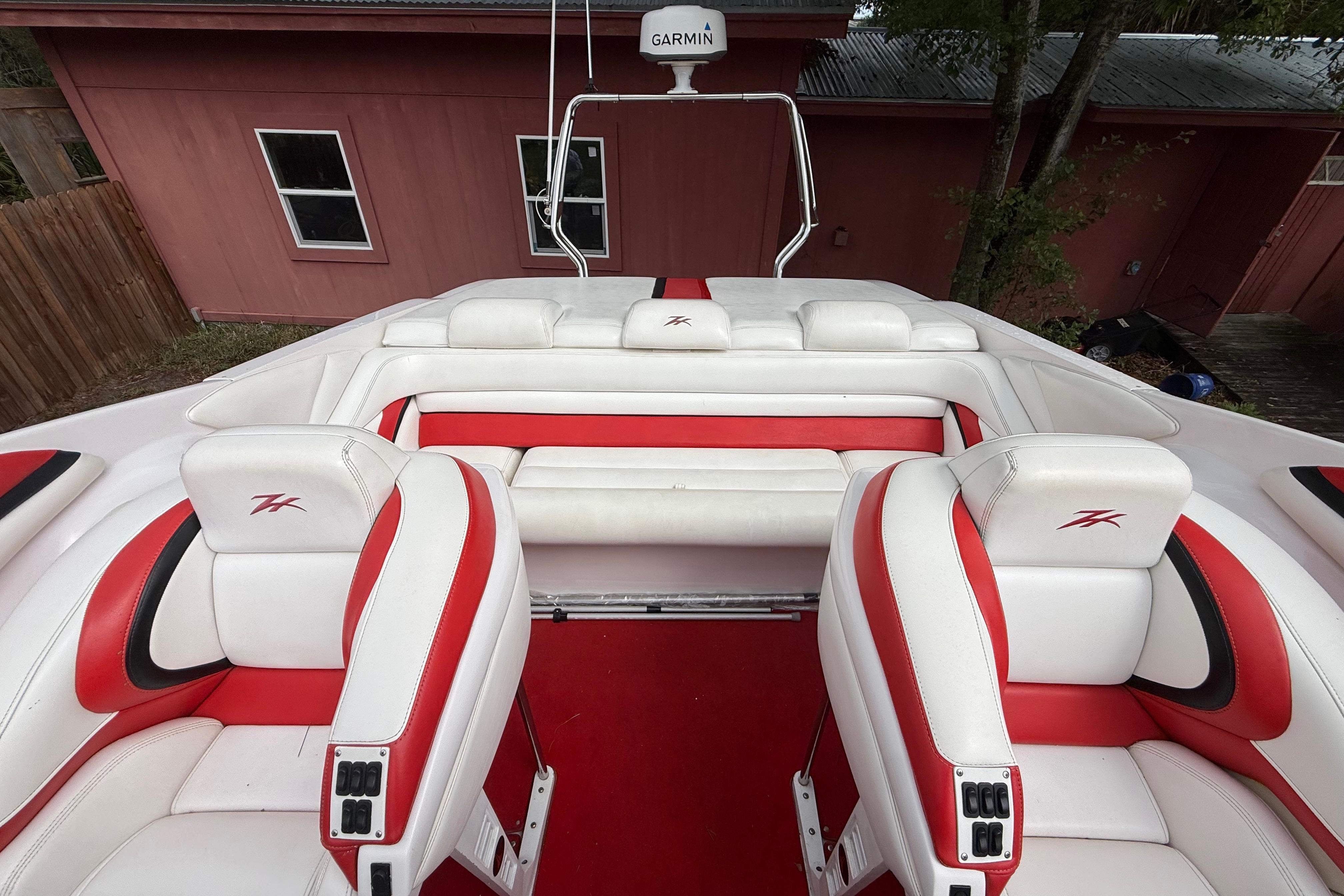 1998 Donzi 33 ZX boat interior with red and white seating, featuring Garmin equipment.