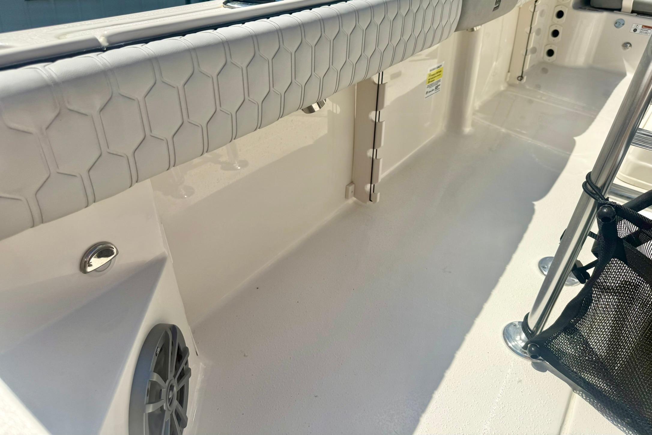 2026 Carolina Skiff 21 Ultra Elite interior with hexagonal pattern upholstery and speaker.