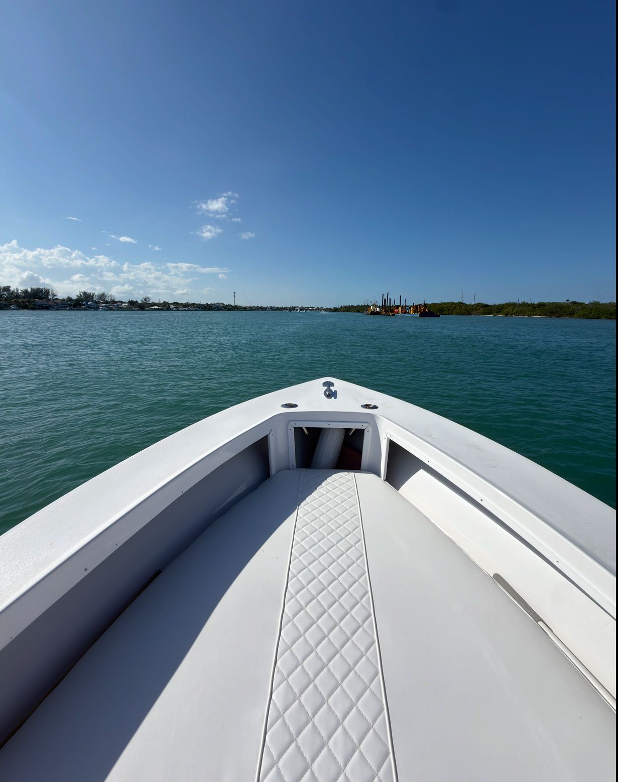 A boat on calm water under a clear sky.