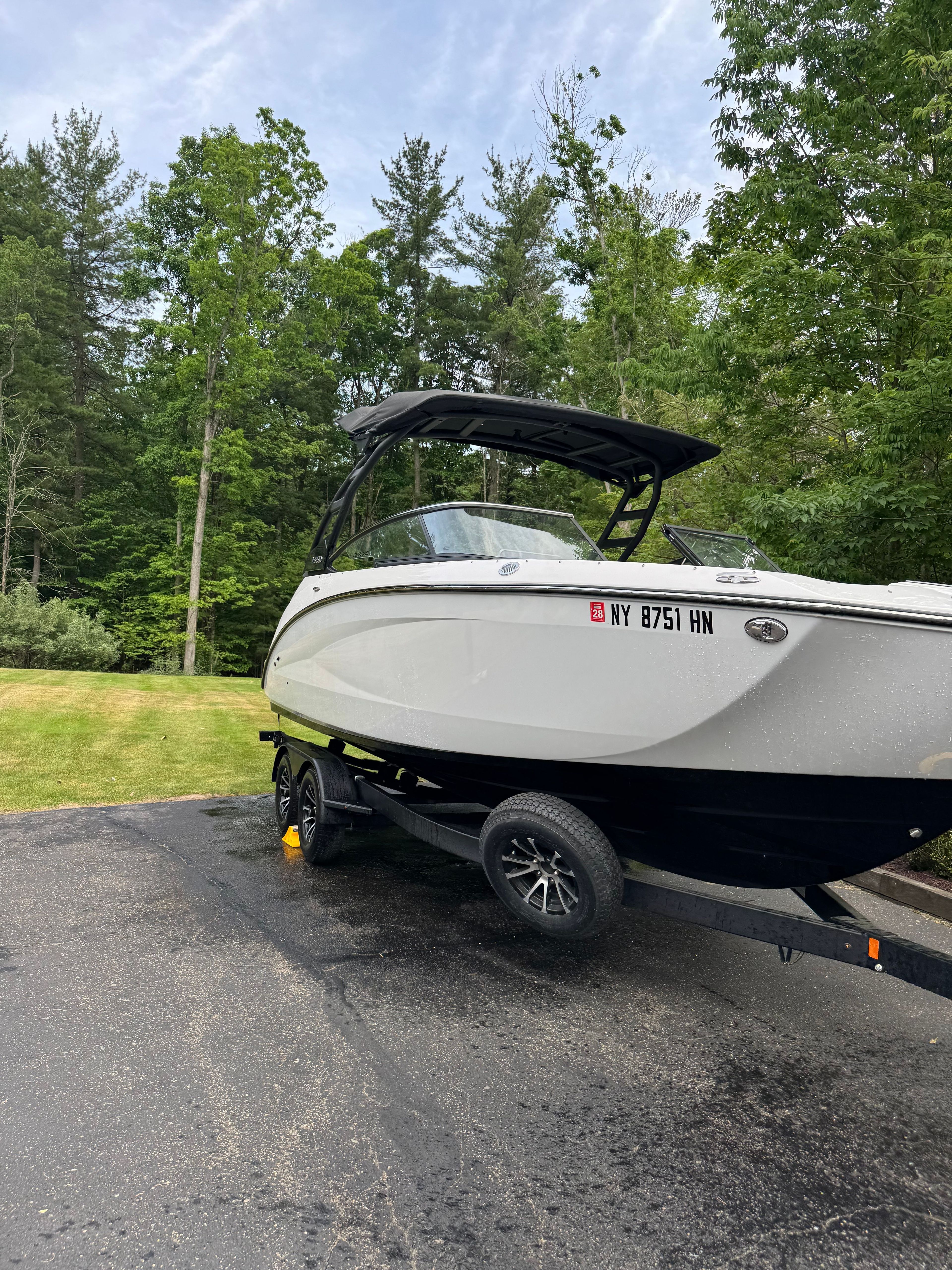 Yamaha 252SD boat 2025 on trailer parked in greenery.