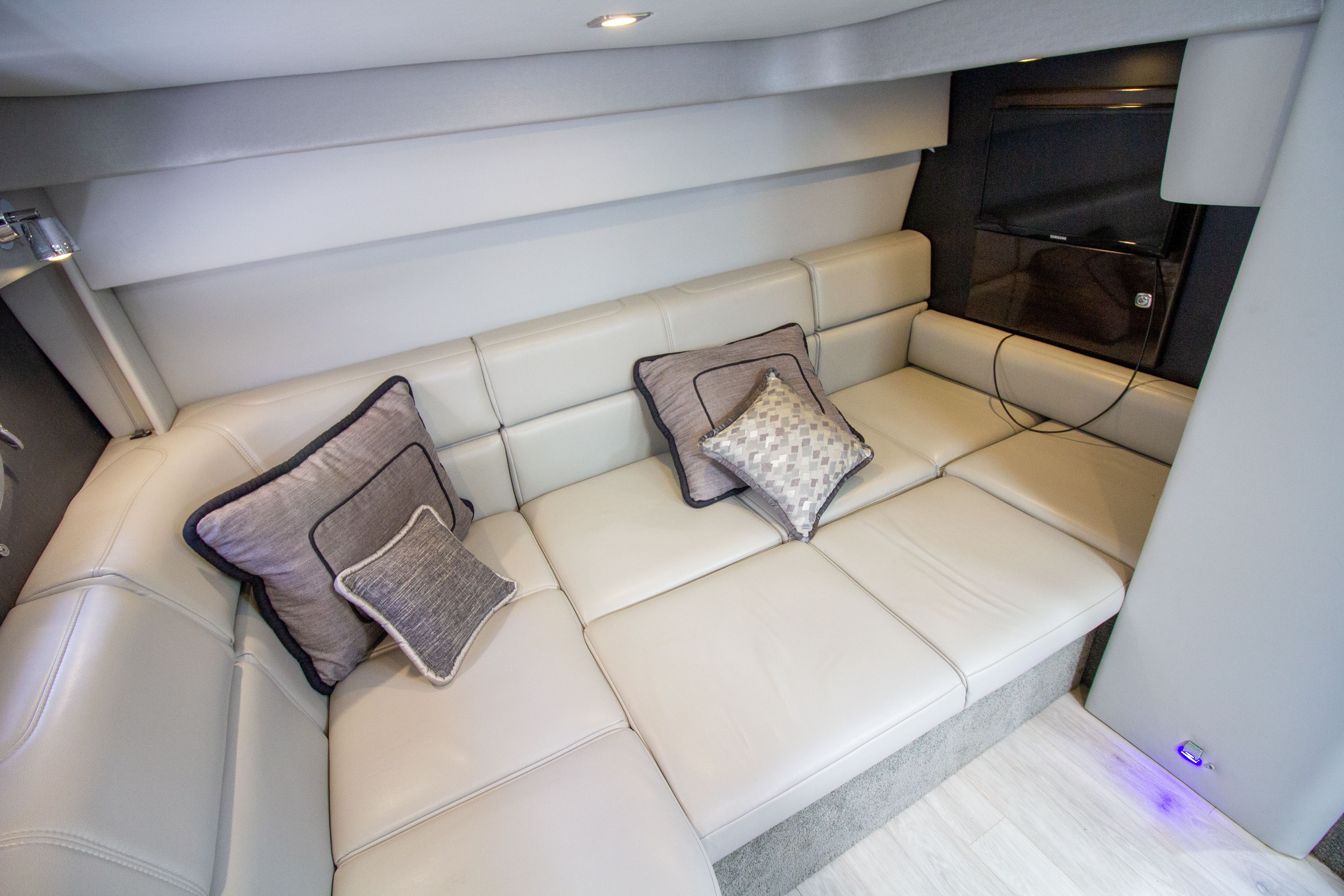 Interior of 2016 Formula 40 Performance Cruiser with beige sofa.