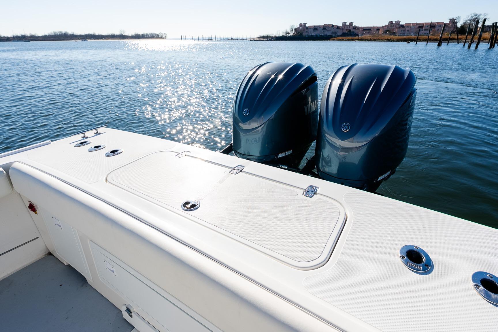 2024 Steiger Craft 31 Fisherman boat with dual outboard motors on a sunny day.