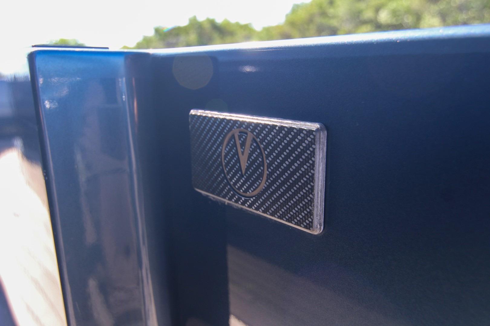 Vanquish Yachts VQ45 2022 model emblem on sleek blue surface.