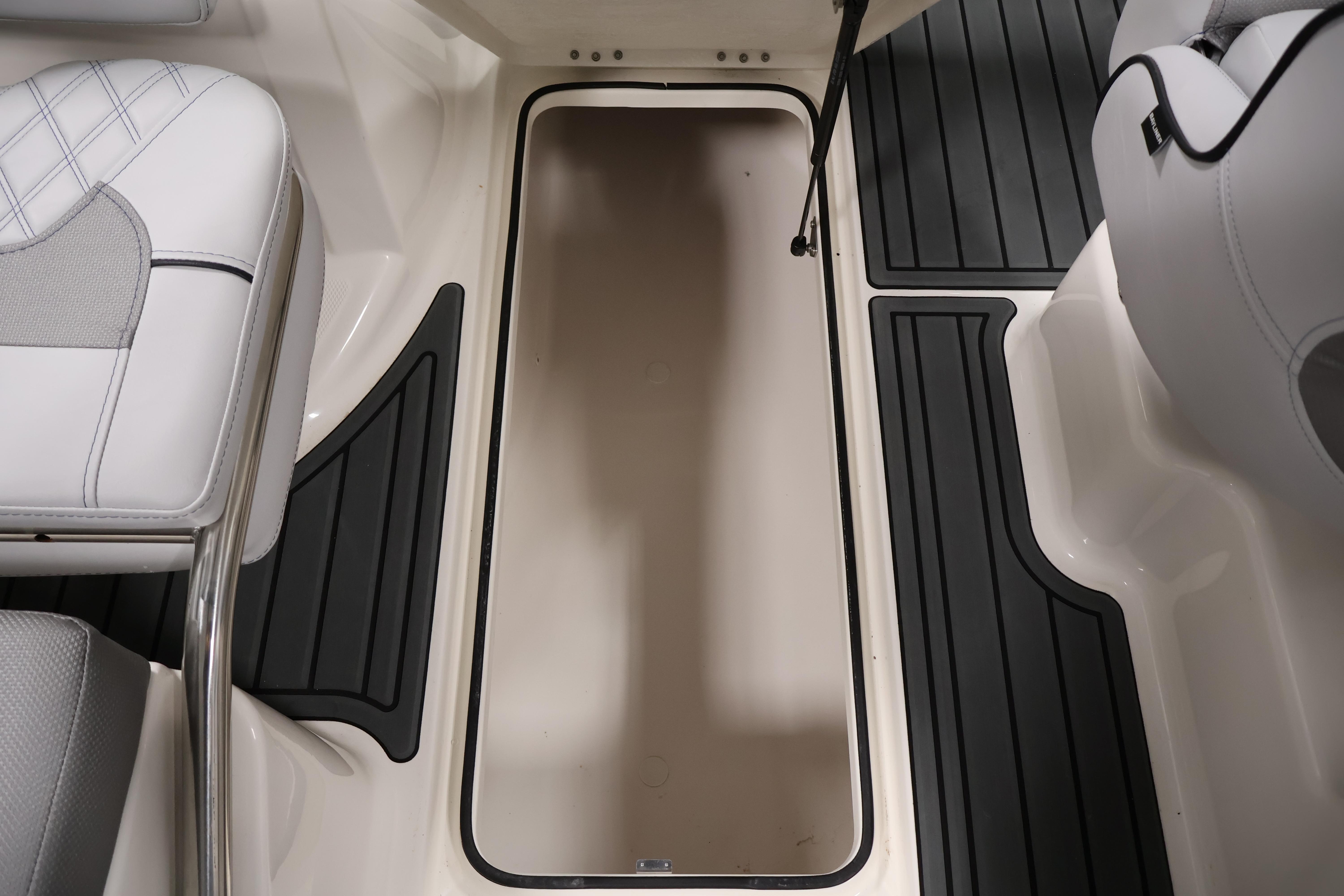 2026 Bayliner VR6 Bowrider I/O interior with storage compartment and cushioned seating.