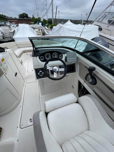 2013 Sea Ray 240 Sundeck boat cockpit with steering wheel and dashboard controls.